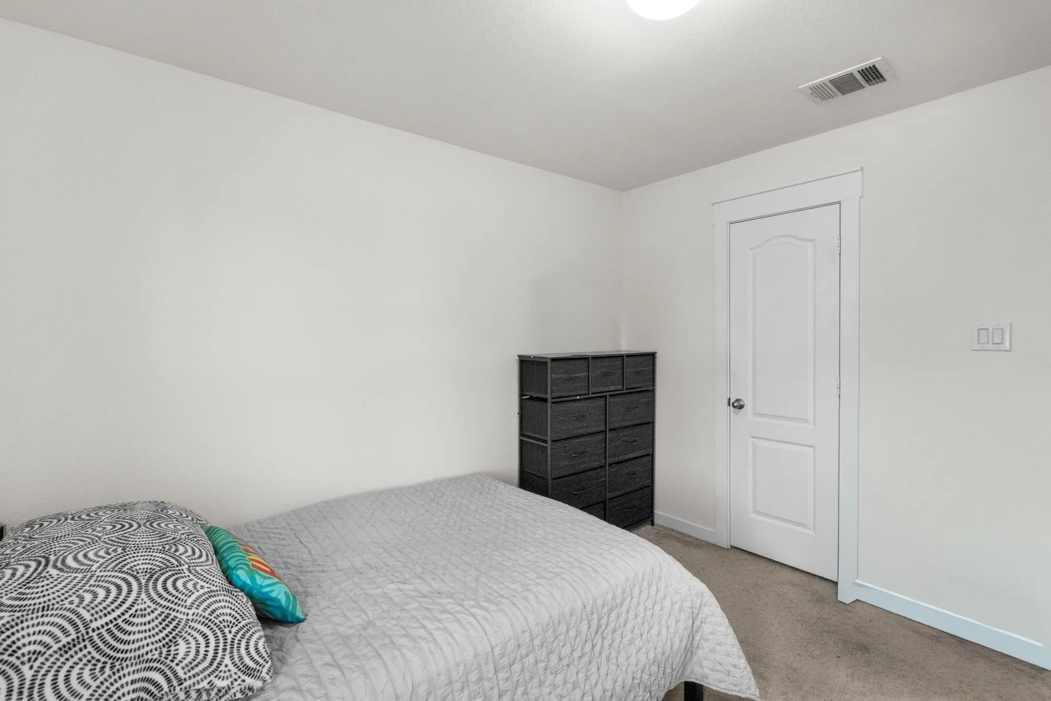Carpeted bedroom with baseboards