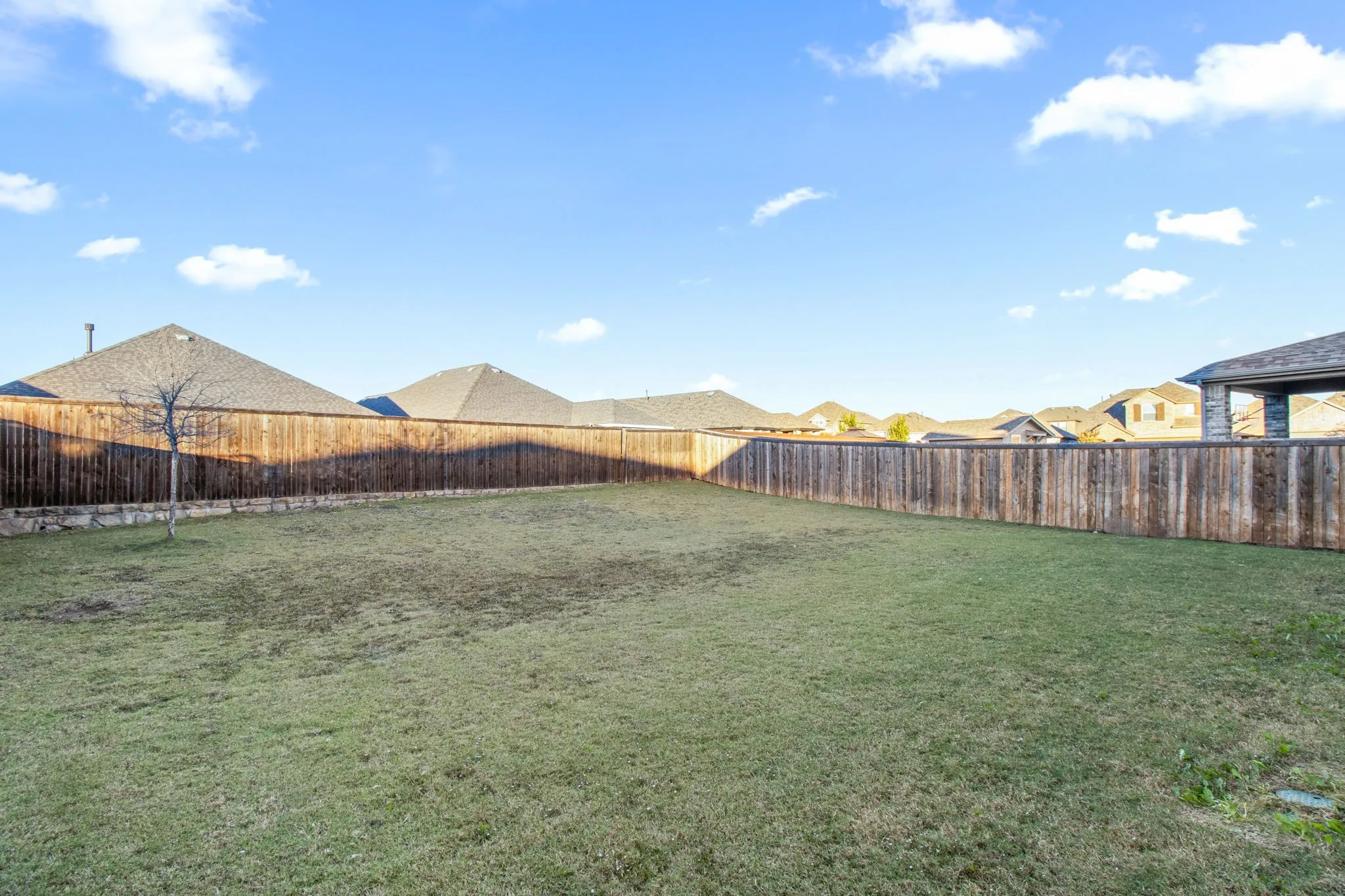Fenced backyard with a residential view
