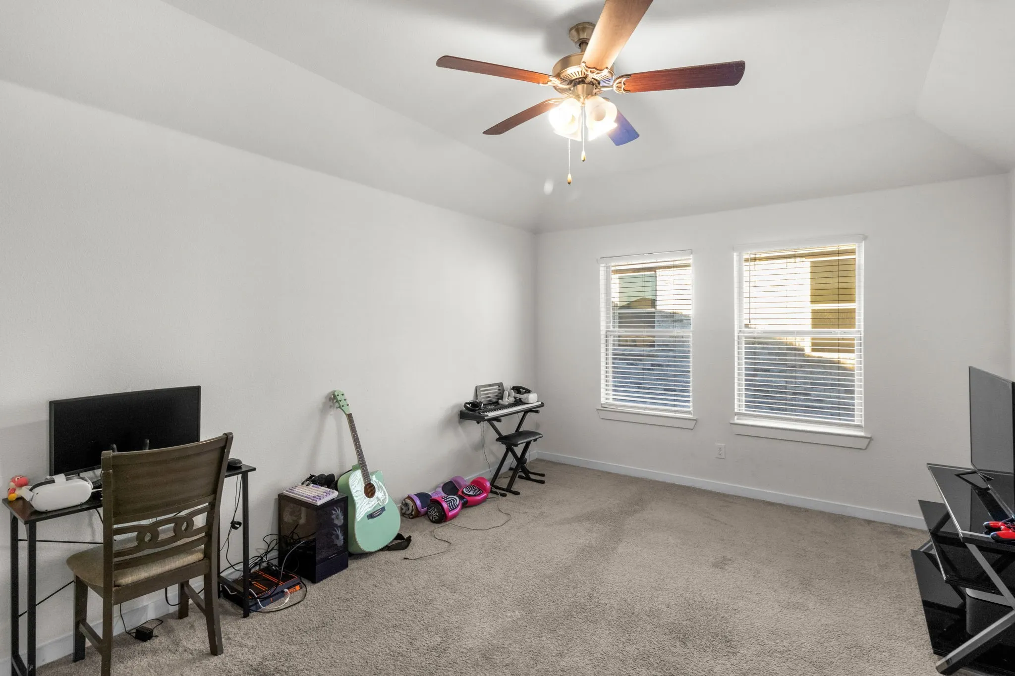 Office with lofted ceiling, light carpet, and ceiling fan