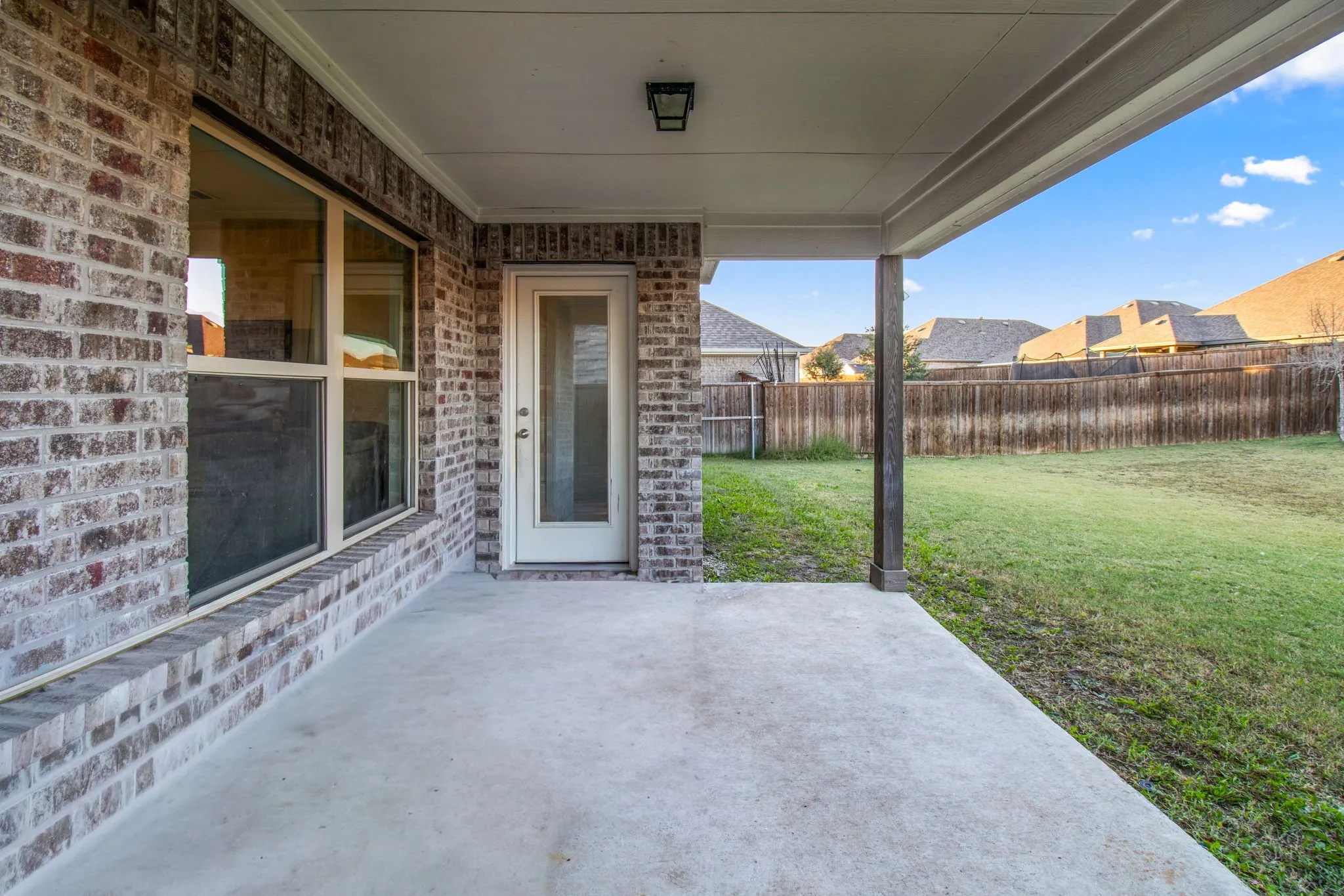 Fenced backyard with a patio area