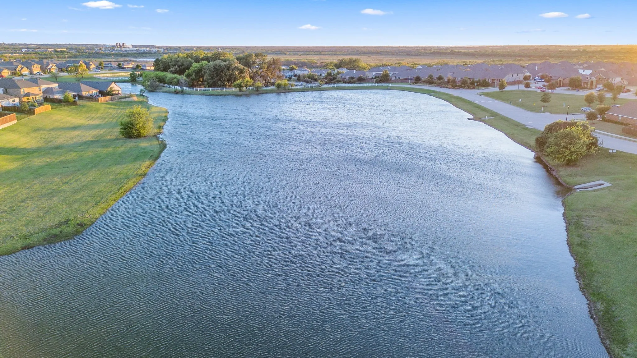 Aerial perspective of suburban area with a large body of water