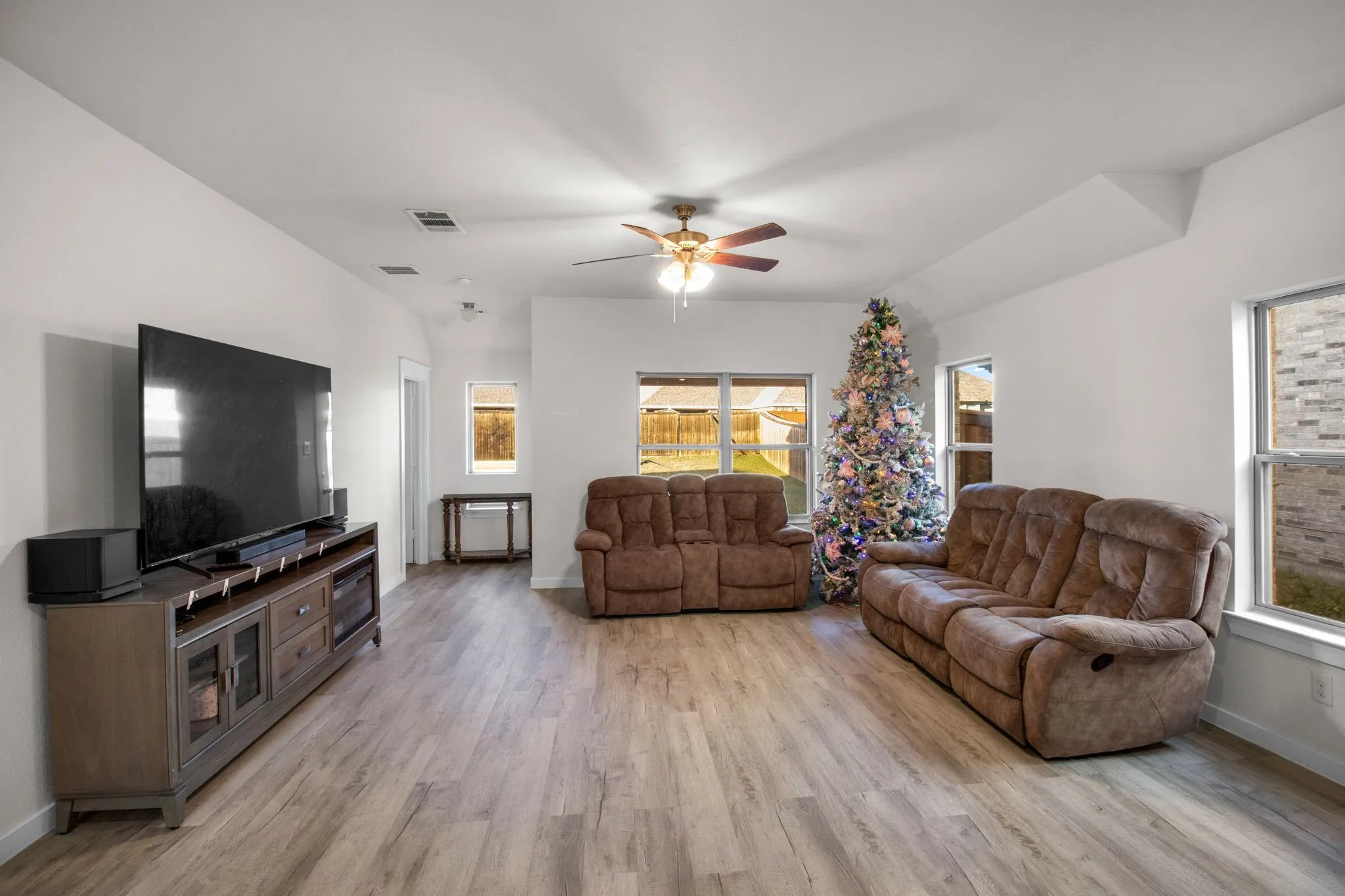 Living area featuring light wood-type flooring and ceiling fan