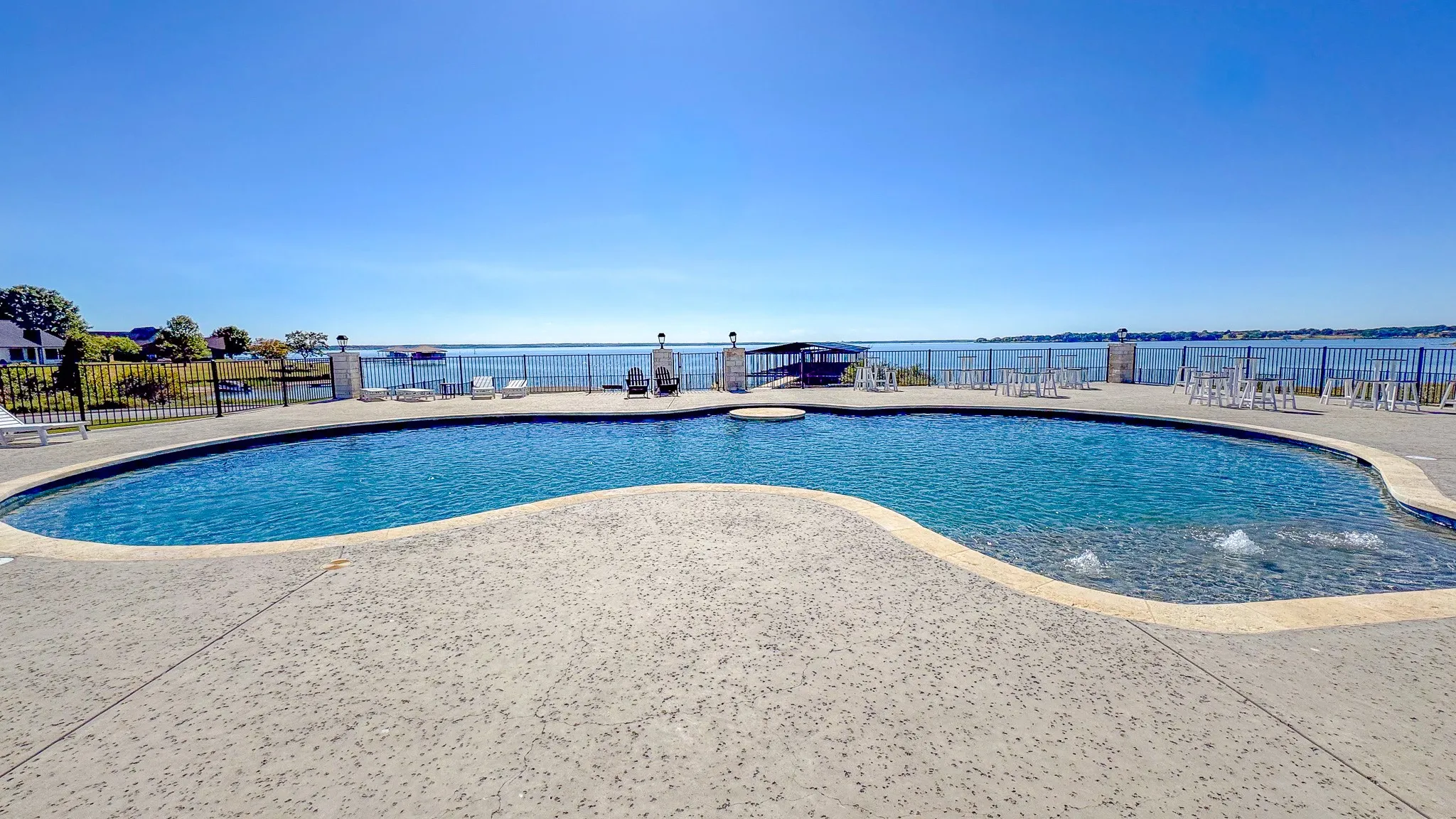 View of pool with a patio and a water view