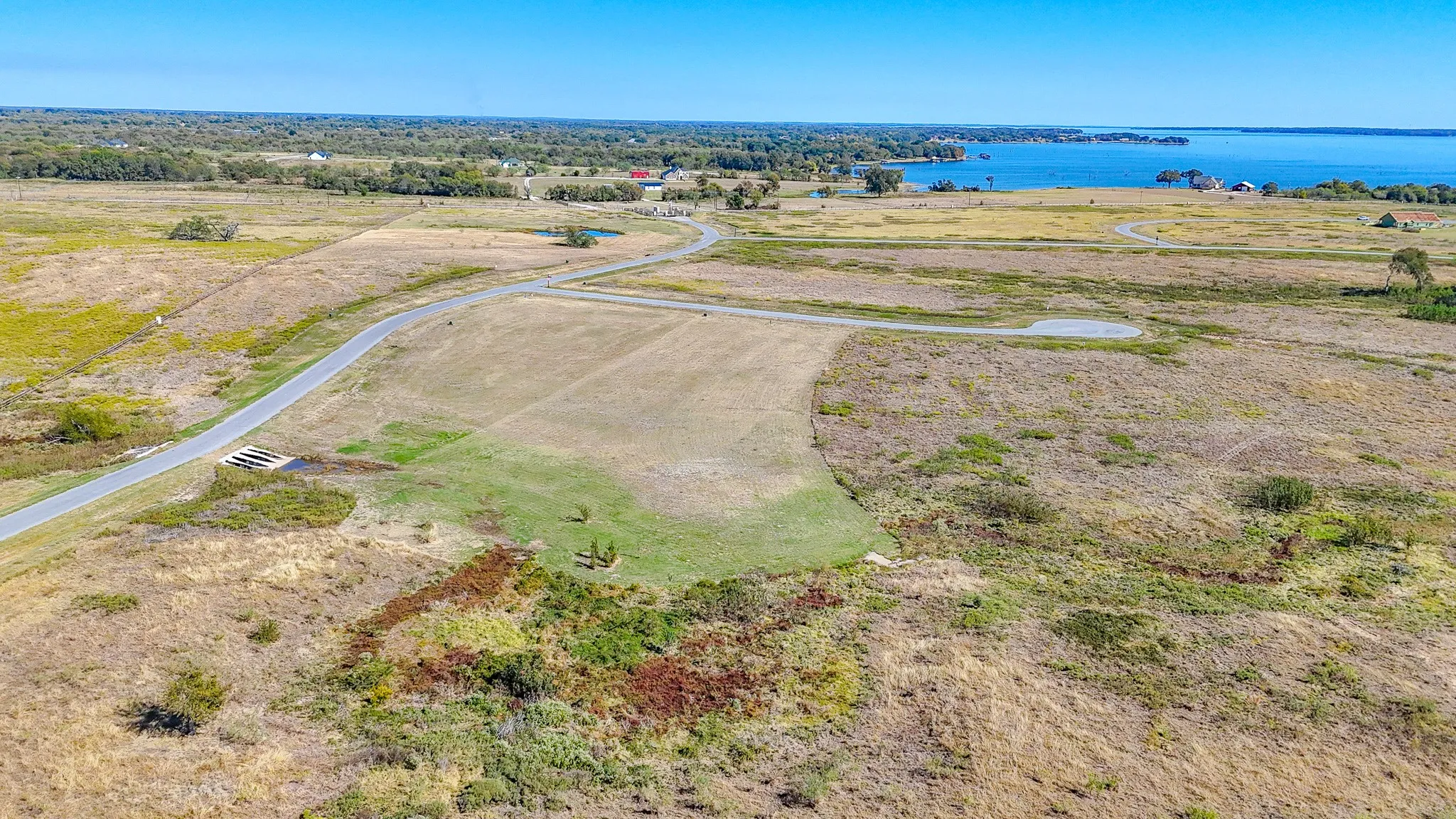 Aerial view of sparsely populated area with a large body of water