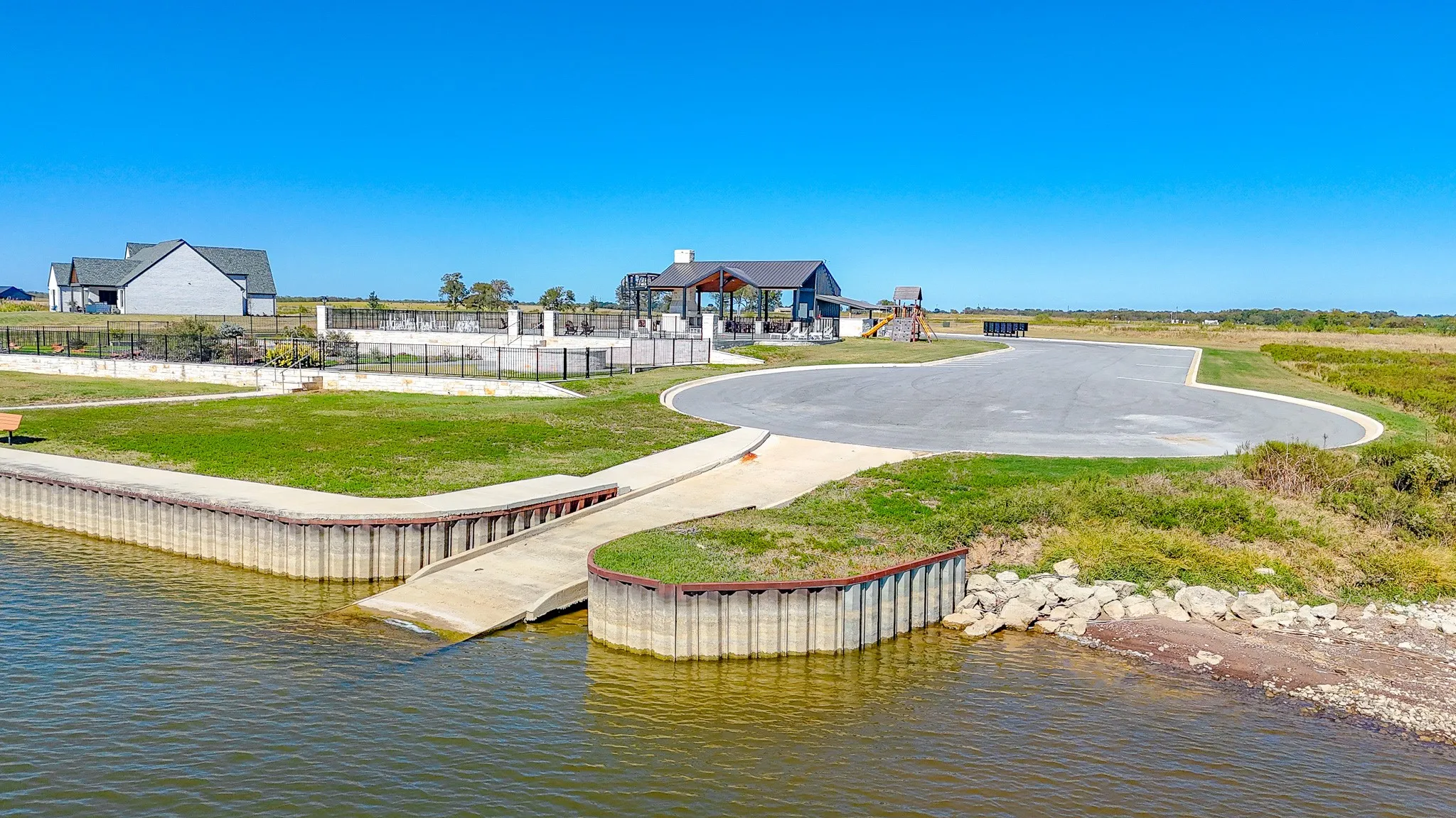 View of community featuring a water view and a yard
