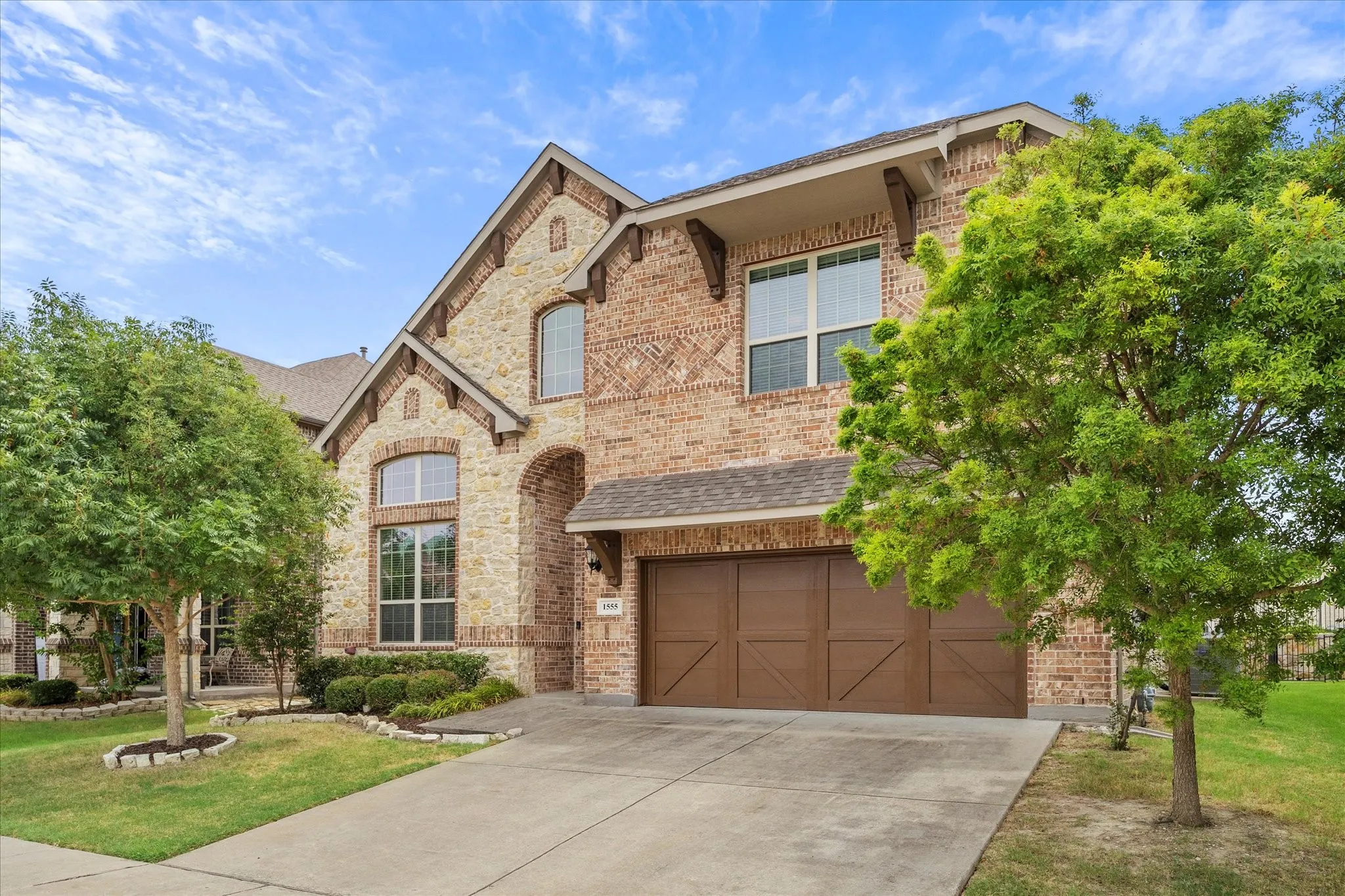 Lush landscaping adds to this home's gorgeous curb appeal.