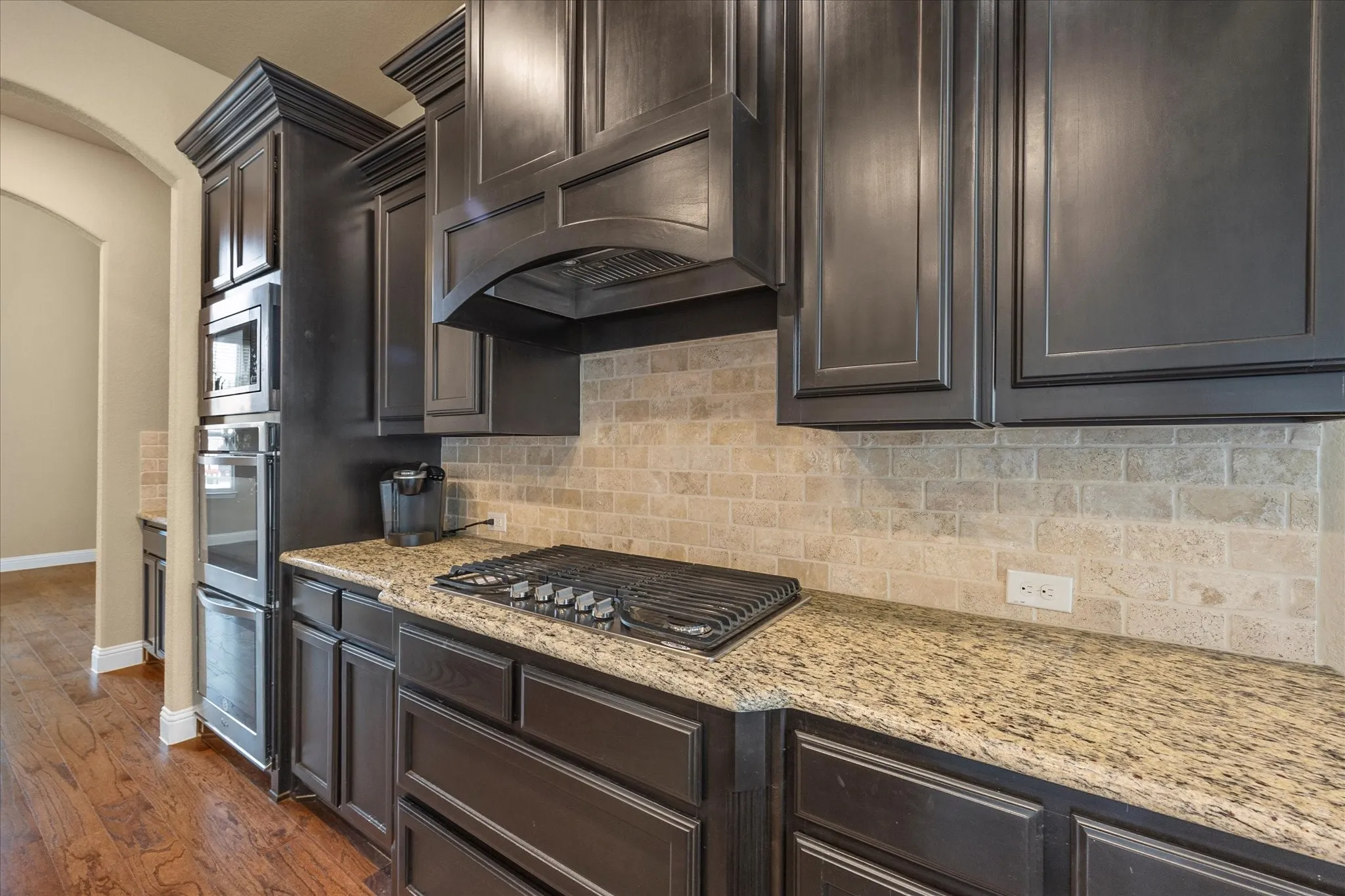 Chef's dream kitchen includes built in stainless steel appliances with gas cooktop!
