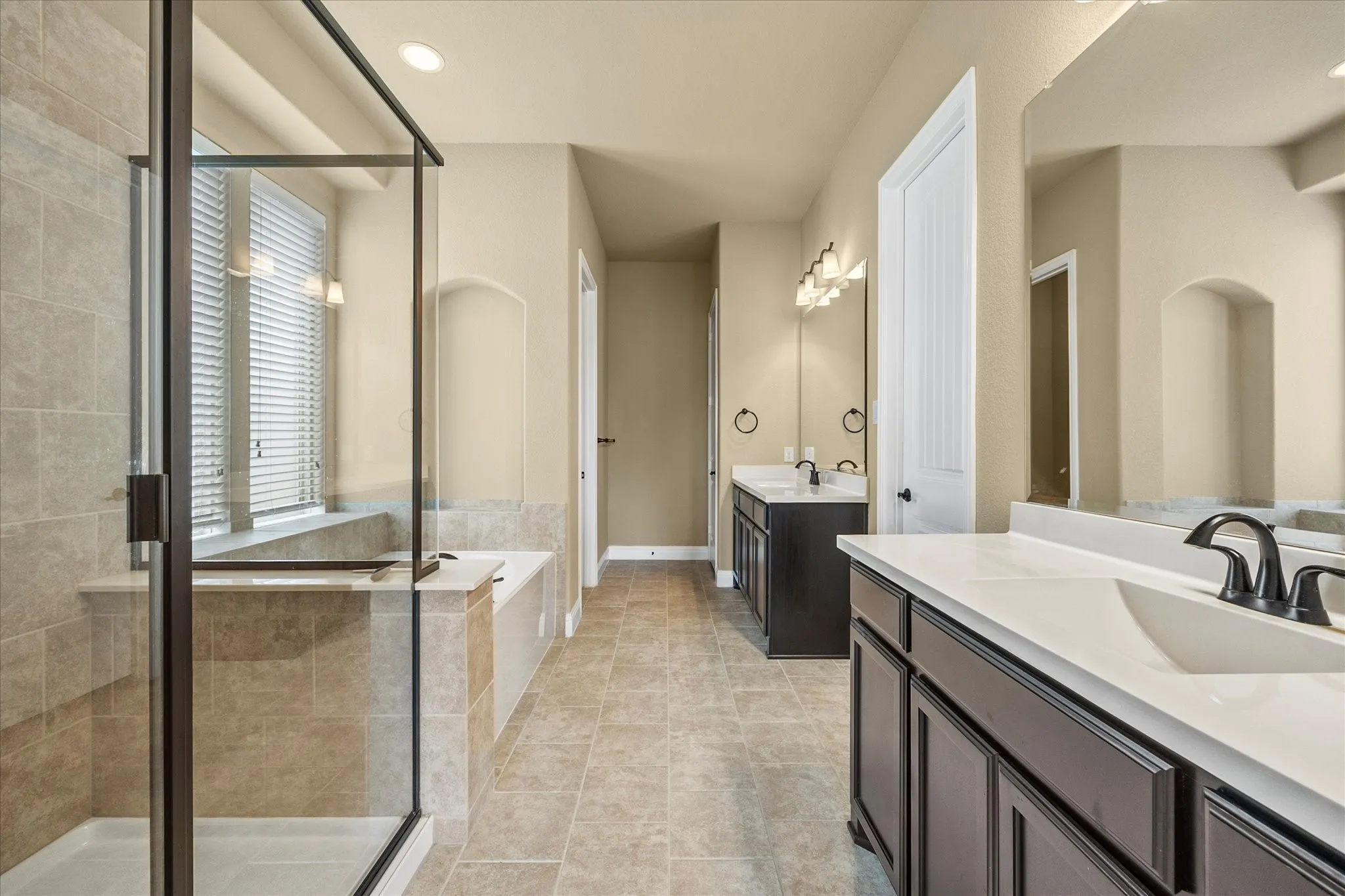 Gorgeous master bath features his and her vanities, garden tub and spa style shower.