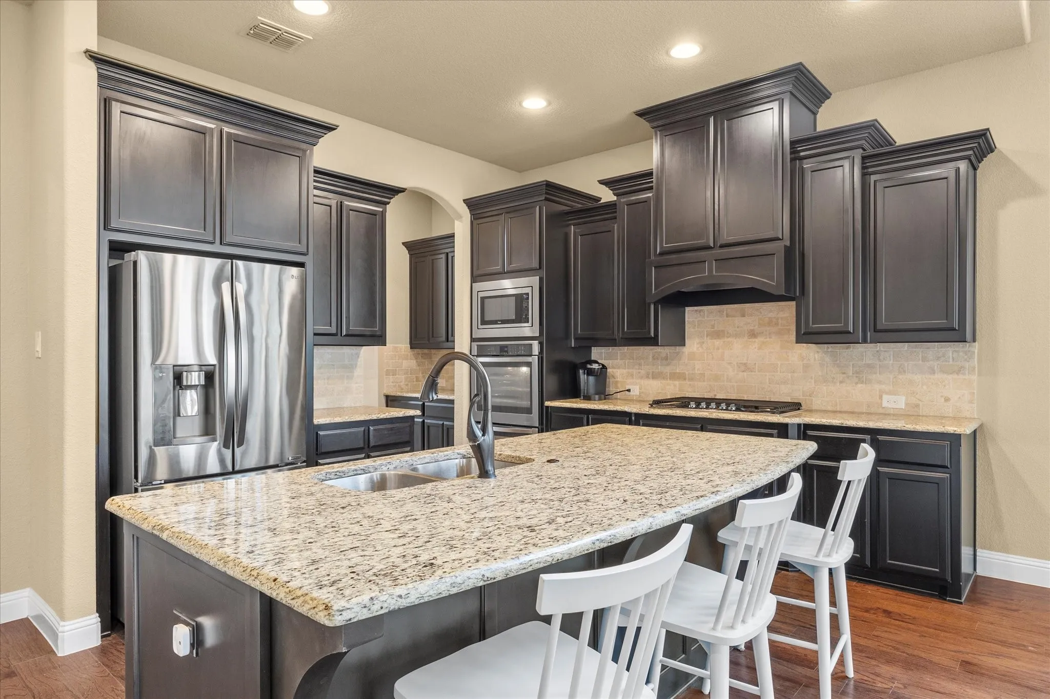 Kitchen features center island-breakfast bar, tons of custom cabinets, granite counter tops & stainless steel appliances.
