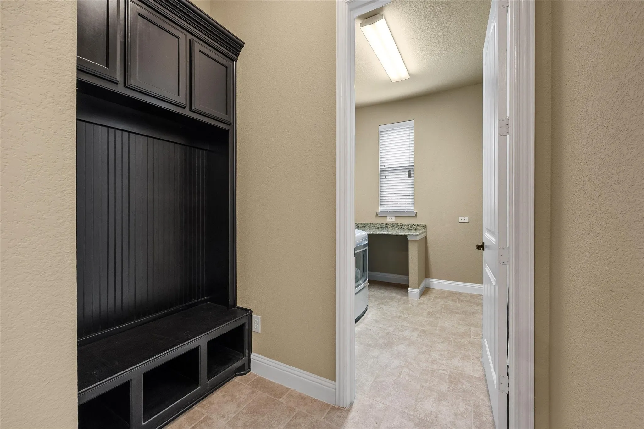 Drop off area includes built ins and is located off laundry room.