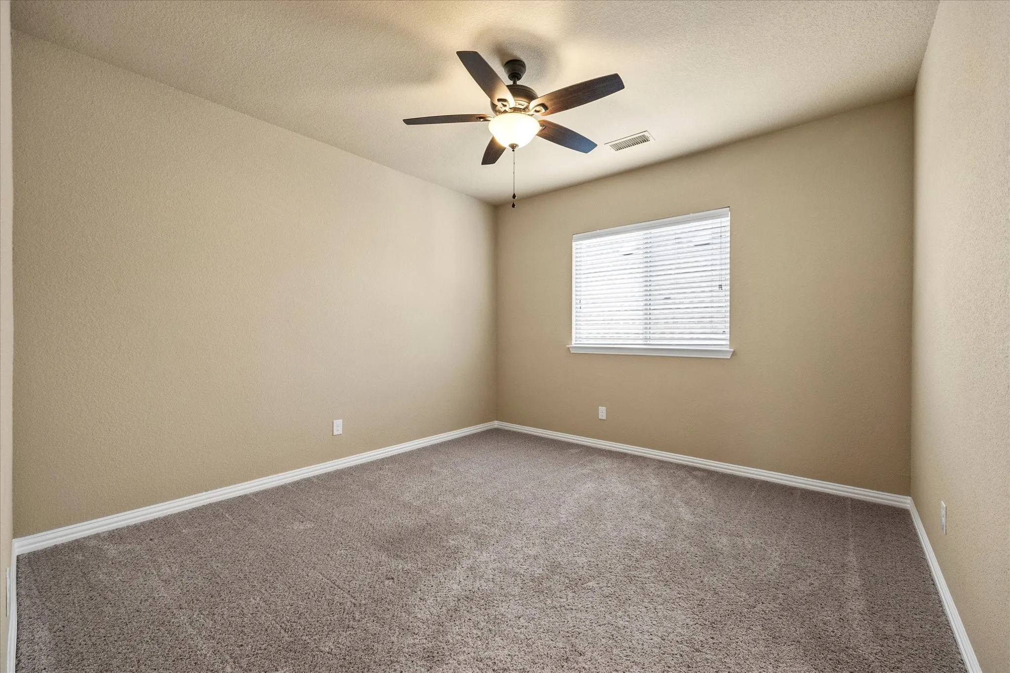 Spacious guest bedroom opens onto full bath