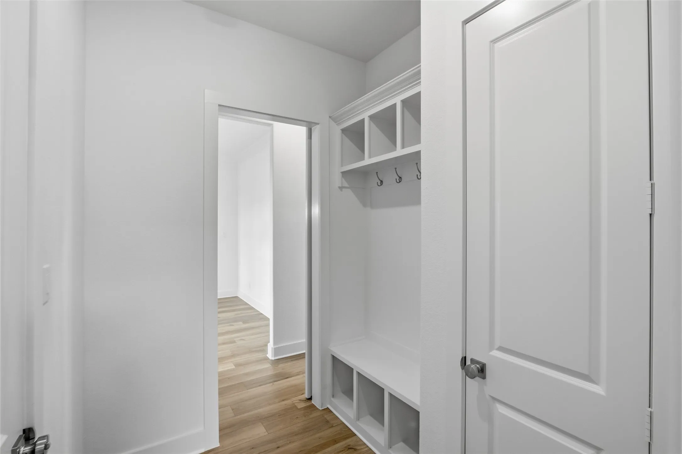 Mudroom with baseboards and light wood-style flooring