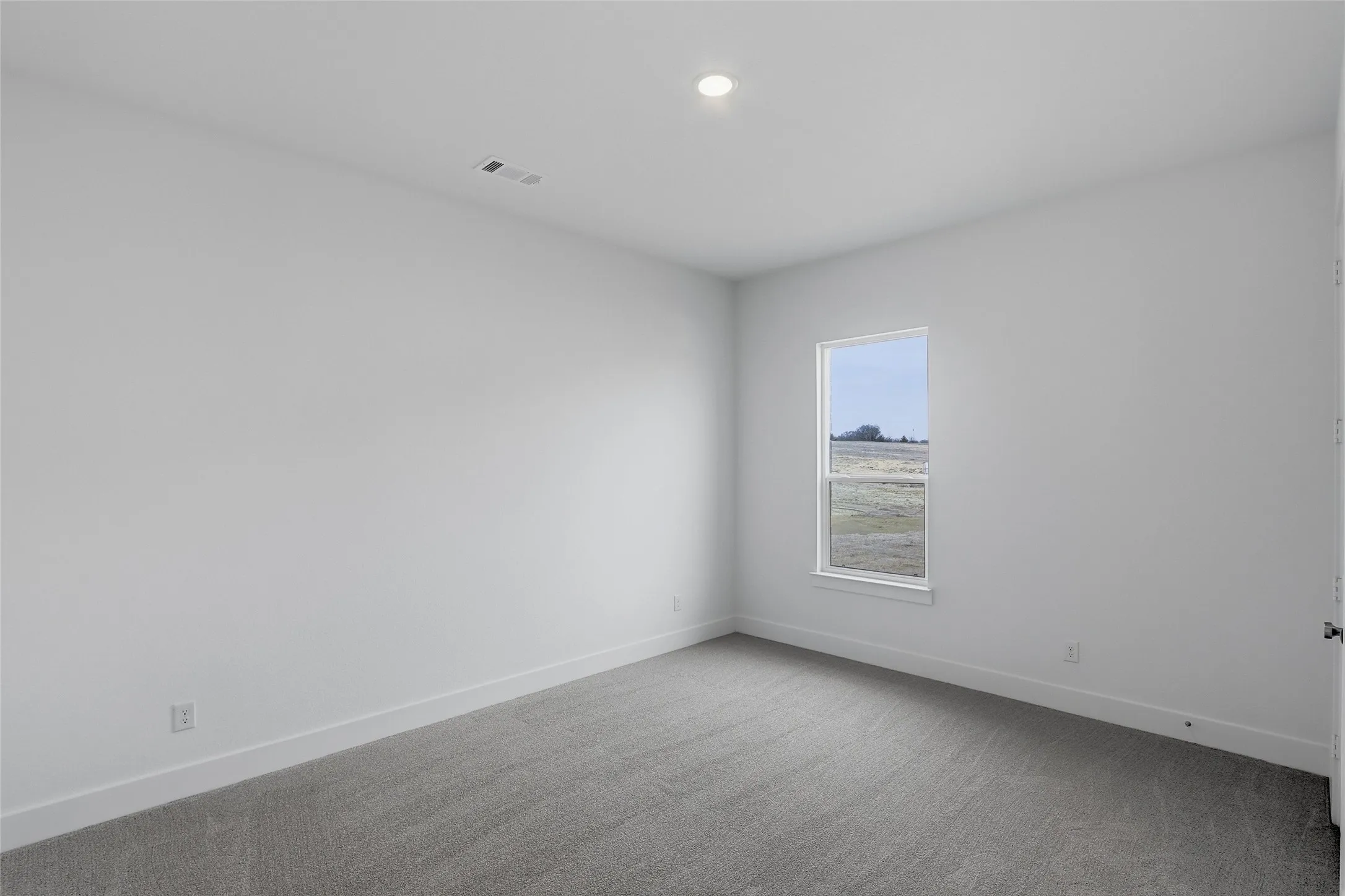 Empty room featuring light colored carpet and recessed lighting