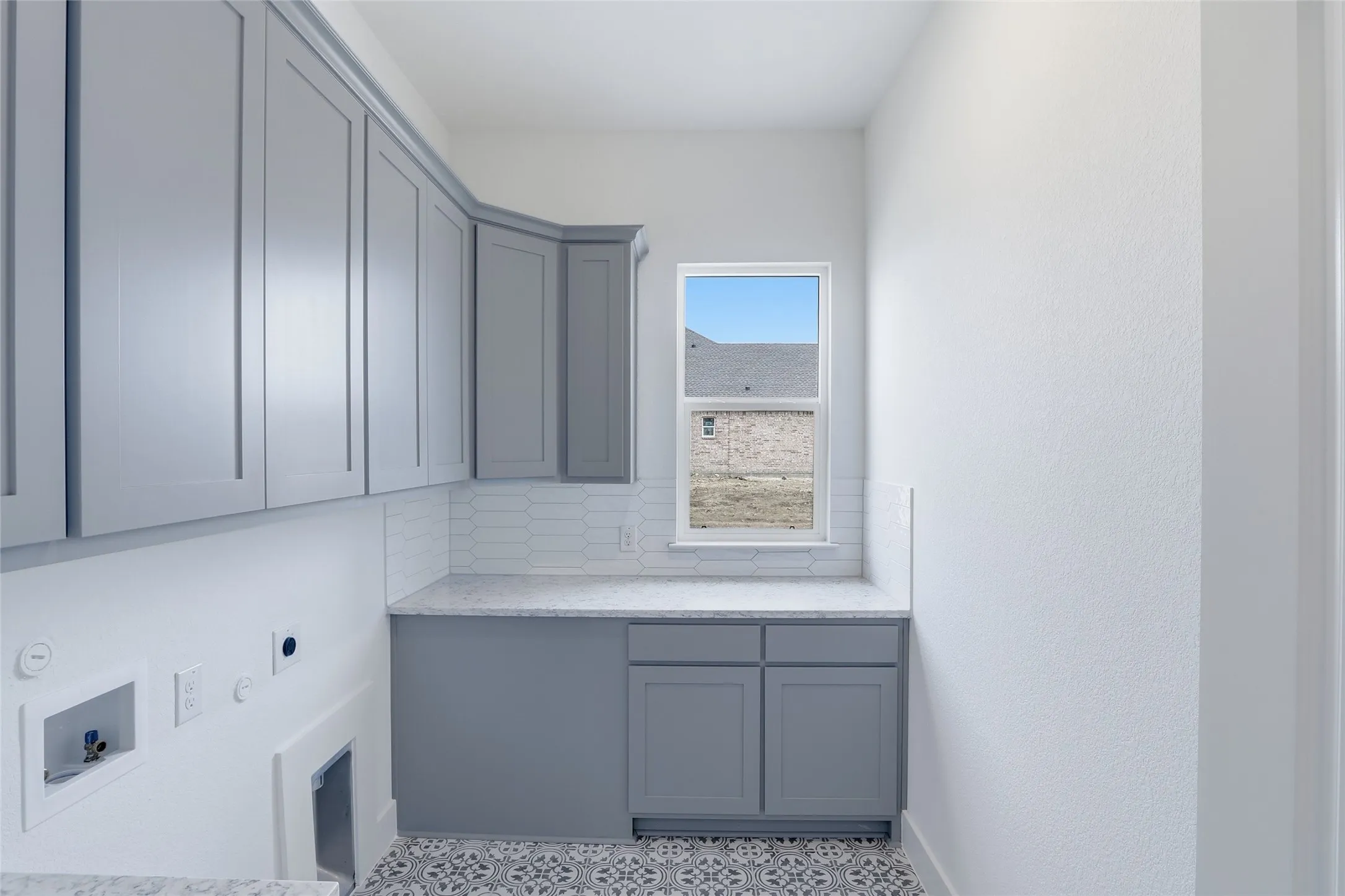 Laundry area featuring hookup for an electric dryer, gas dryer hookup, cabinet space, and washer hookup