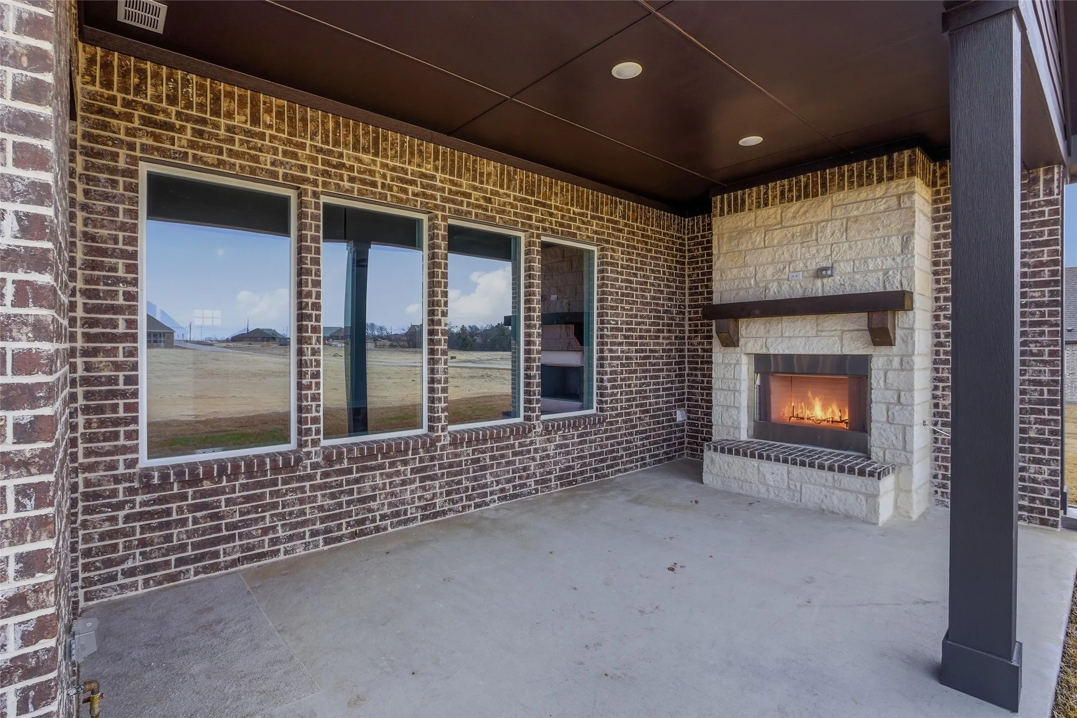 View of patio with a fireplace