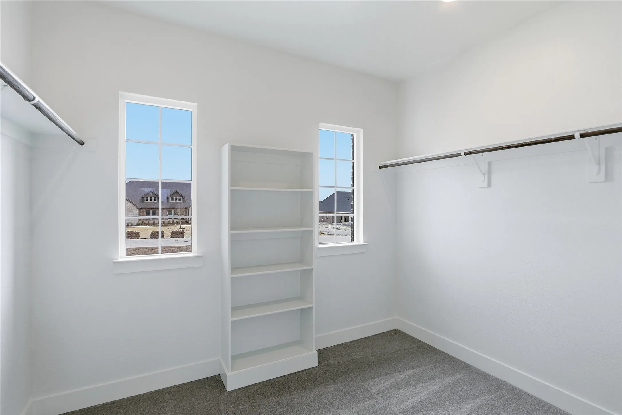 Walk in closet featuring dark carpet