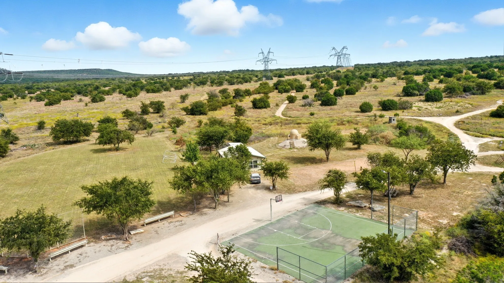 Aerial view of sparsely populated area featuring a tree filled landscape