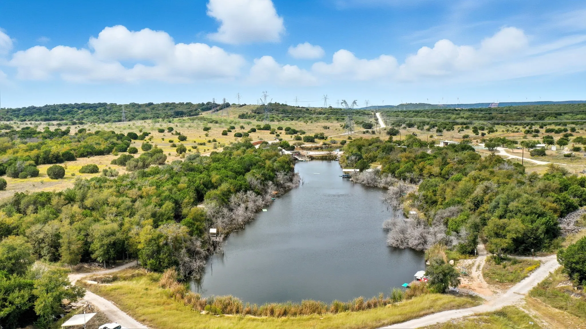 View of rural area with a large body of water and a tree filled landscape