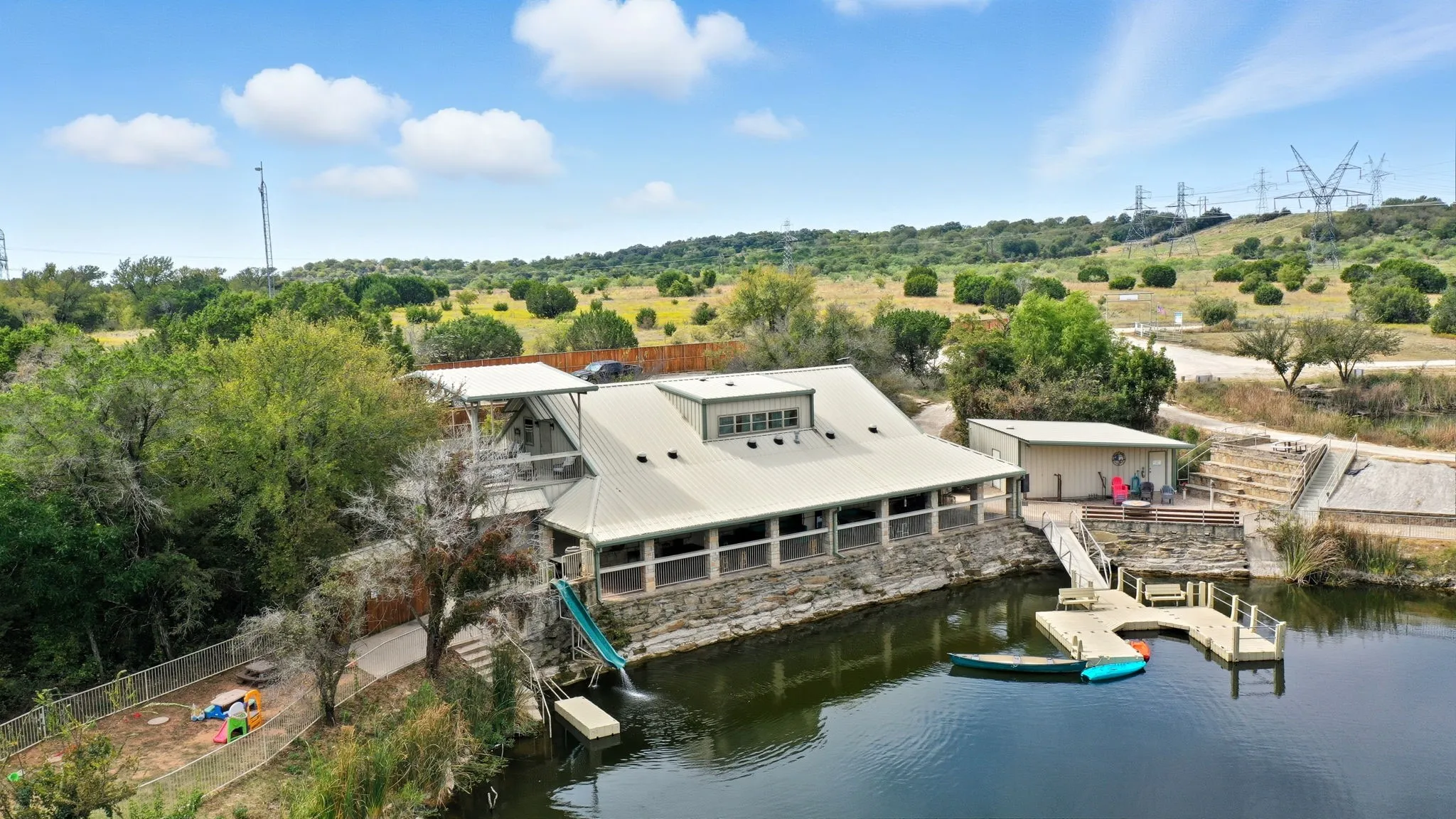 View from above of property featuring a large body of water and a tree filled landscape