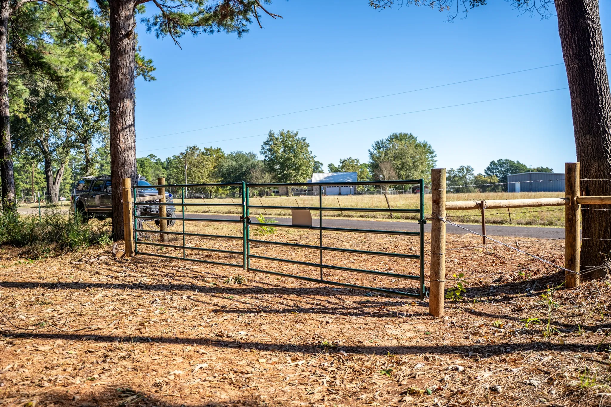 Gate featuring view of scattered trees