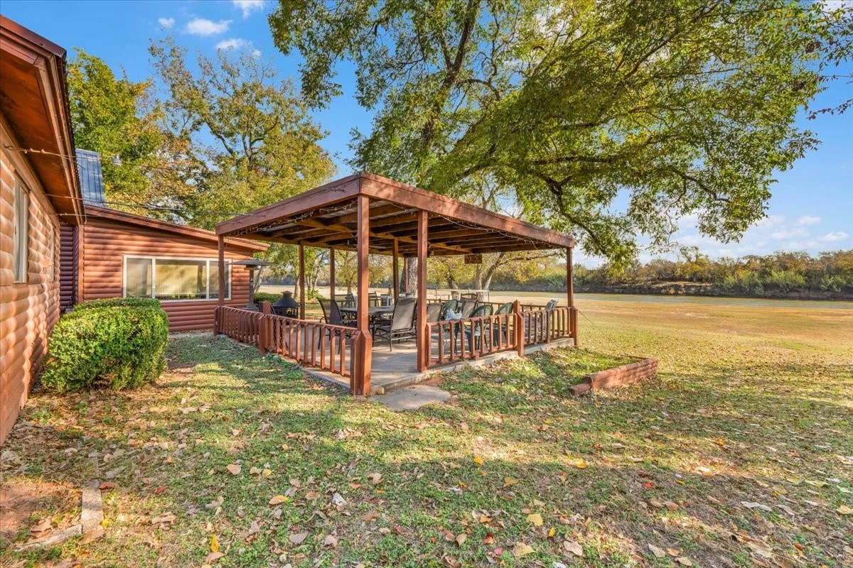 View of green lawn with a deck
