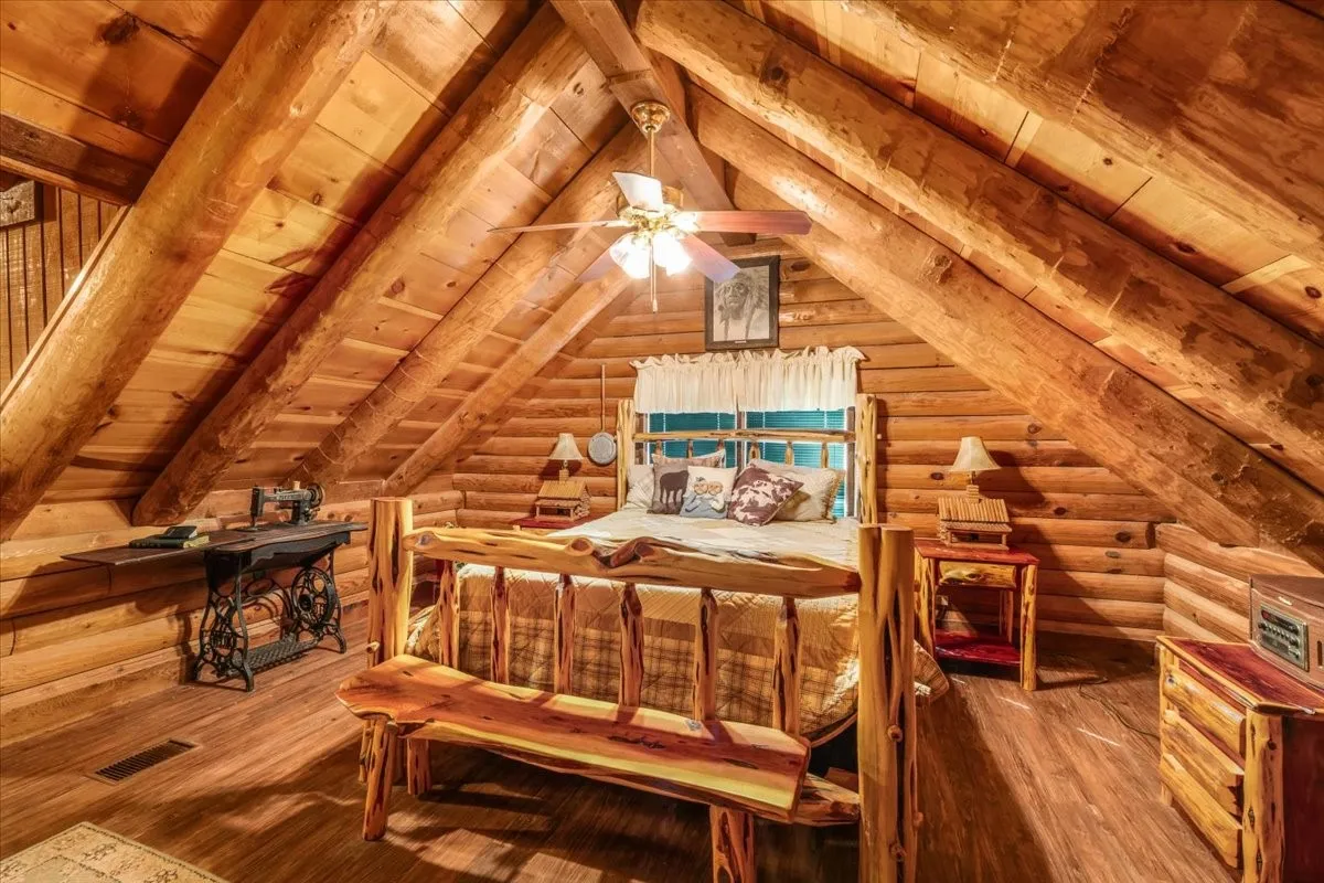 Bedroom featuring wooden ceiling, wood finished floors, and rustic walls