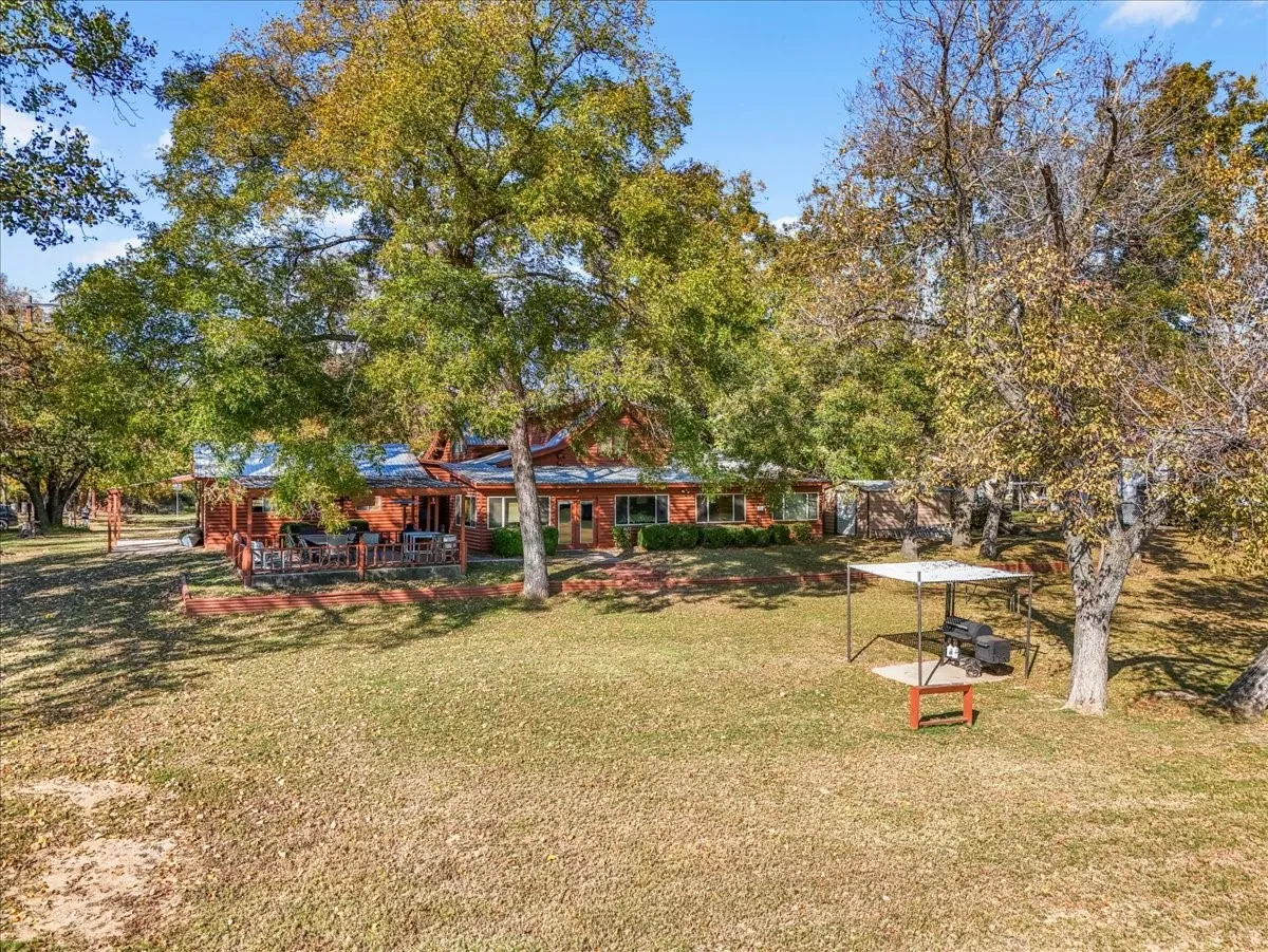 View of grassy yard with a patio area