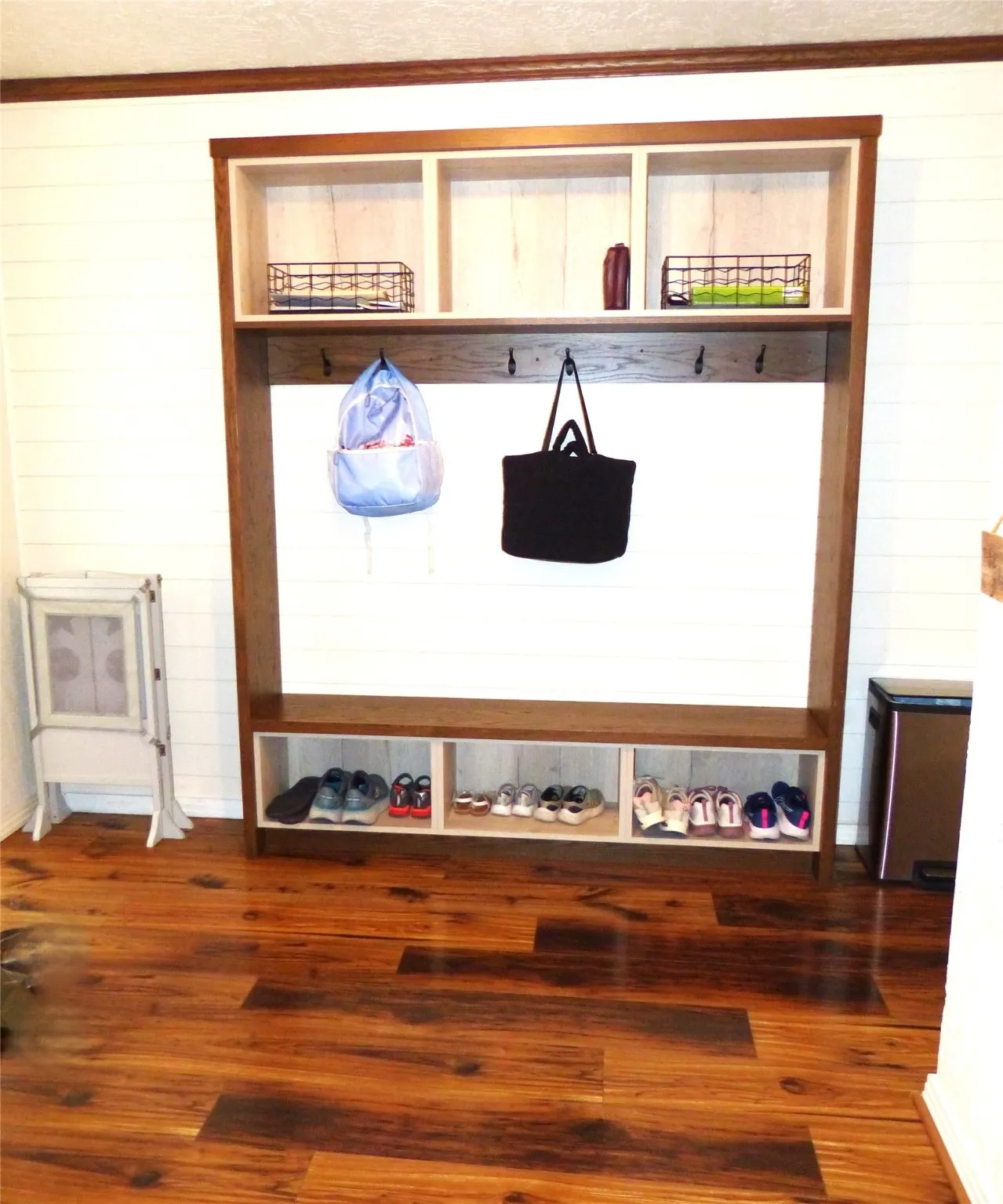 Mudroom with wood finished floors and wood walls