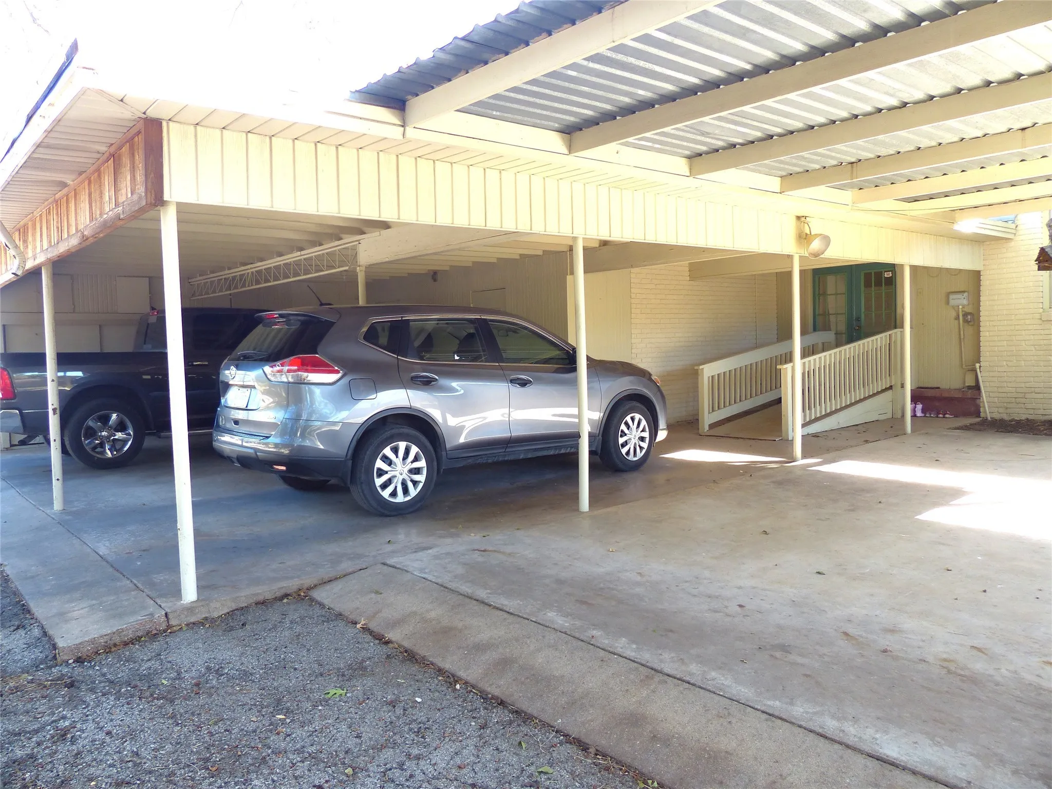 View of parking with a carport
