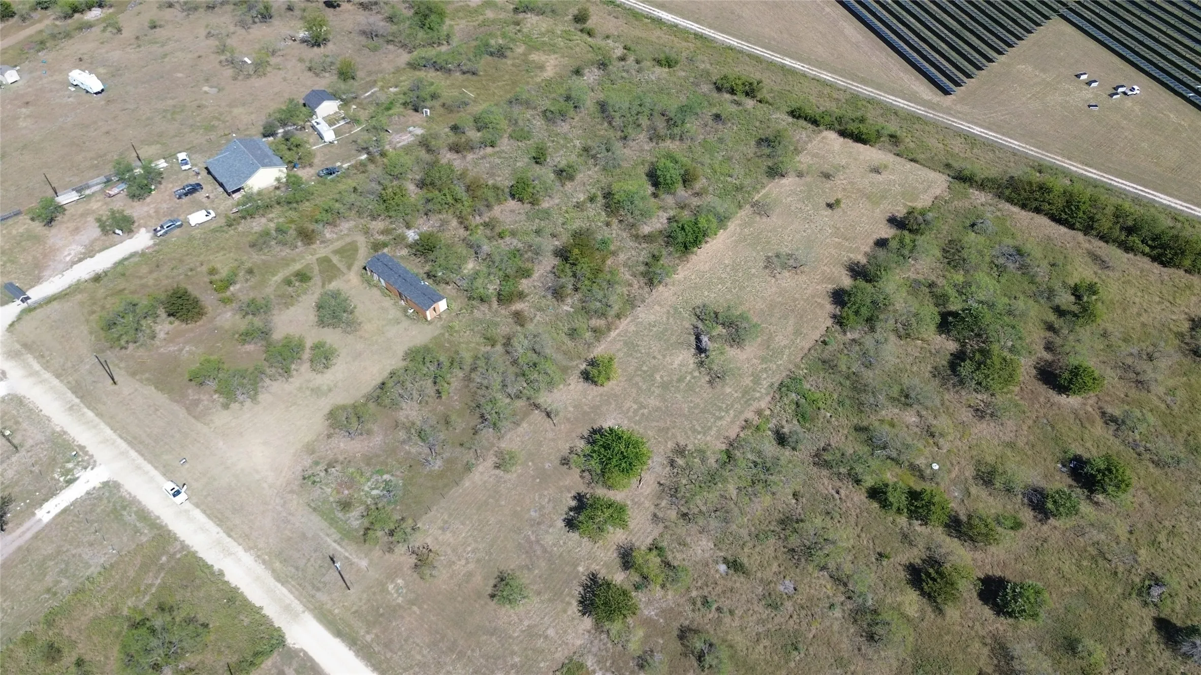 Aerial view of property and surrounding area featuring rural landscape