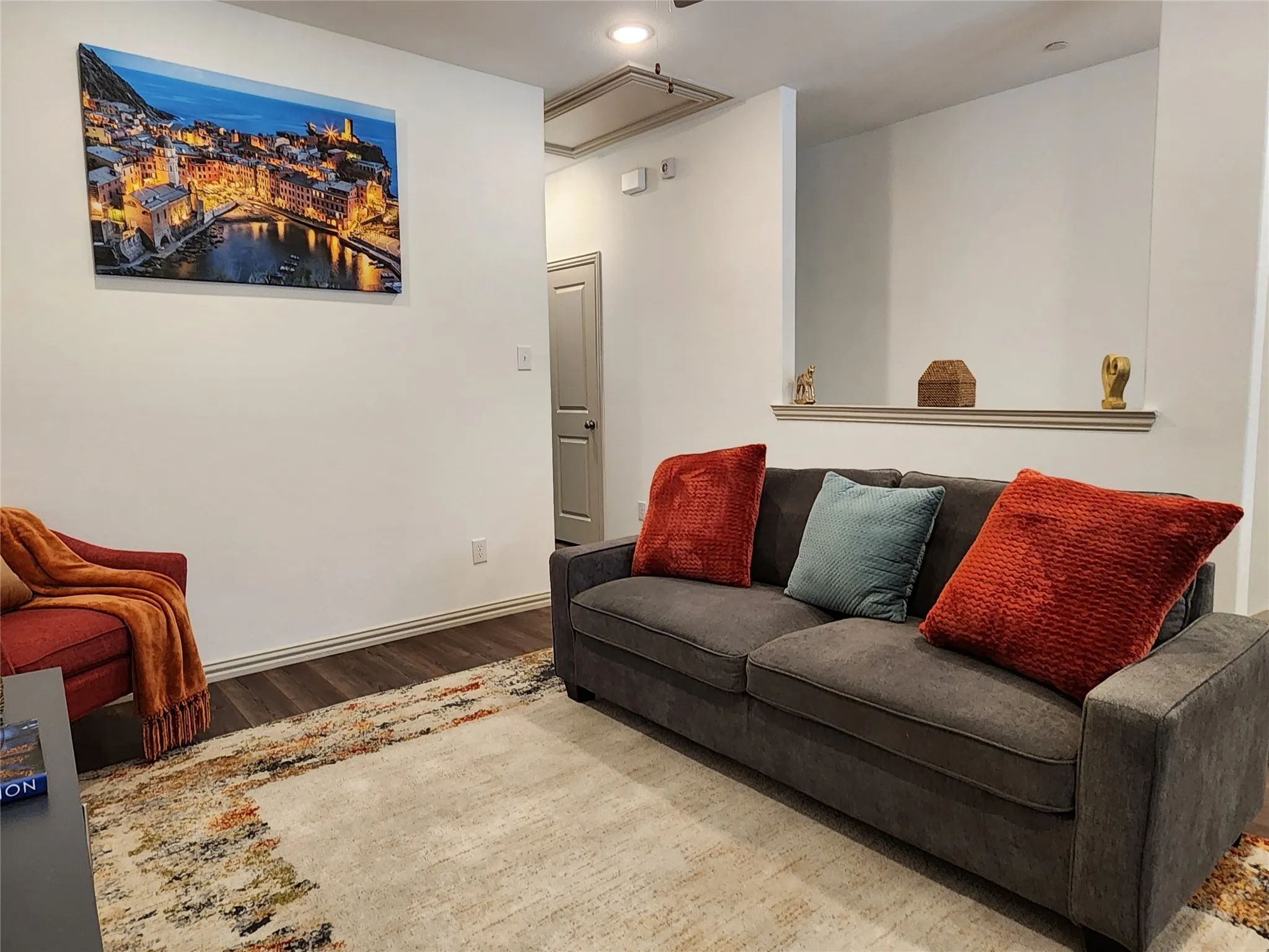 Living room with wood finished floors and recessed lighting