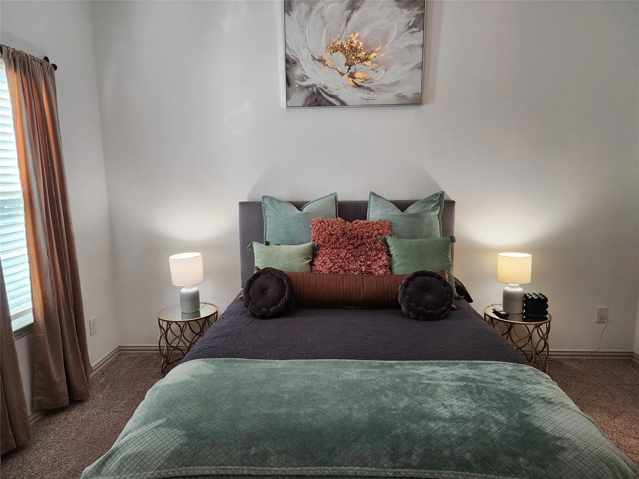 Bedroom with dark colored carpet and baseboards
