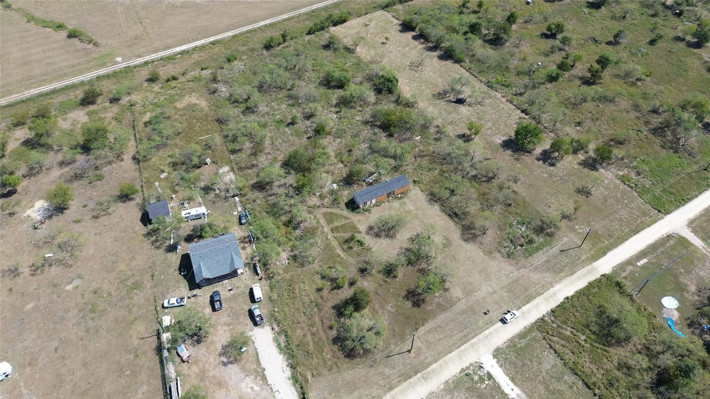 Aerial view of property and surrounding area featuring rural landscape