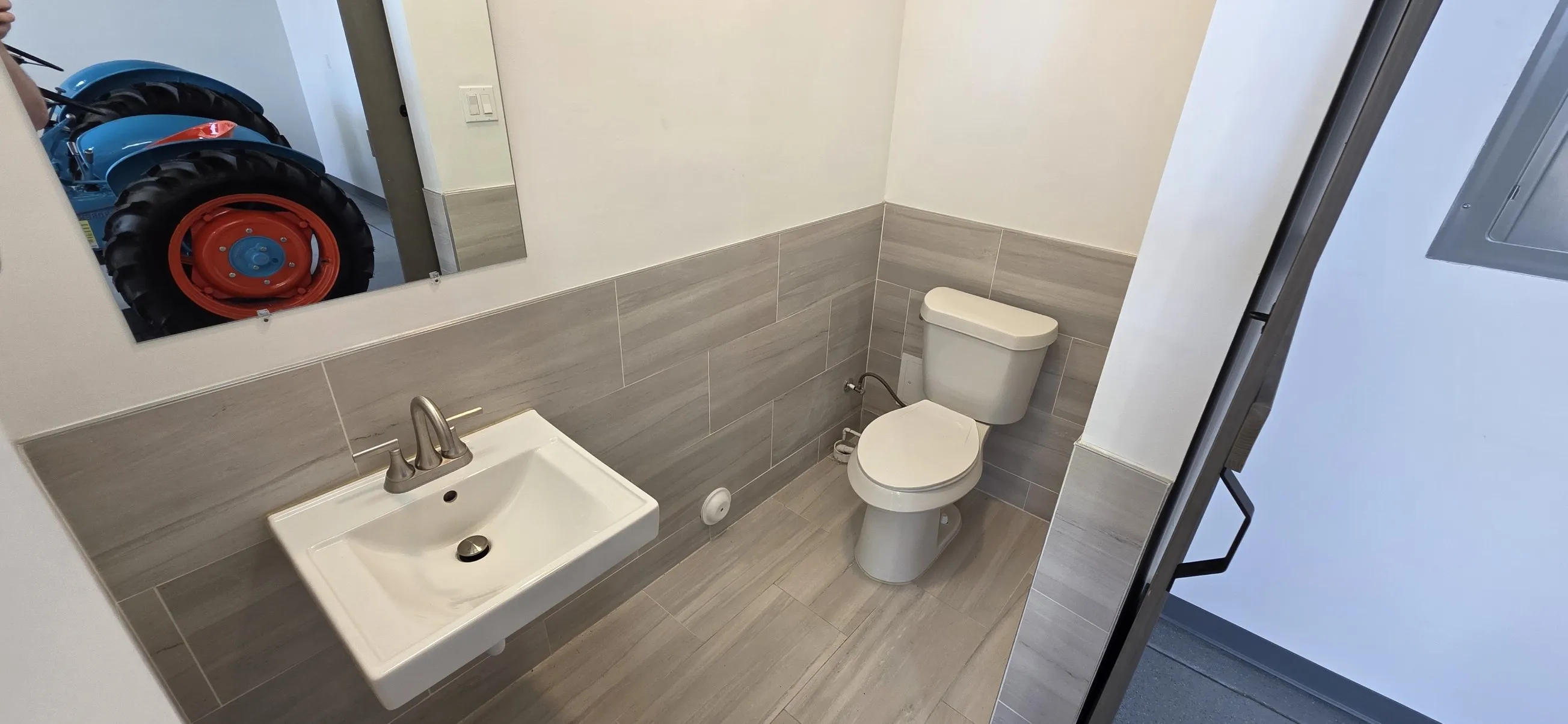 Bathroom with toilet and tile walls