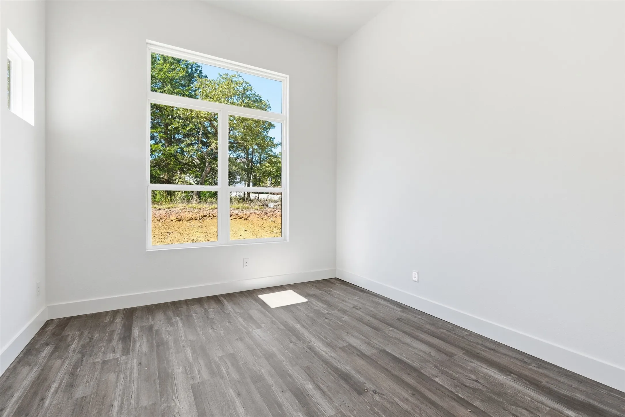 Empty room with wood finished floors and baseboards