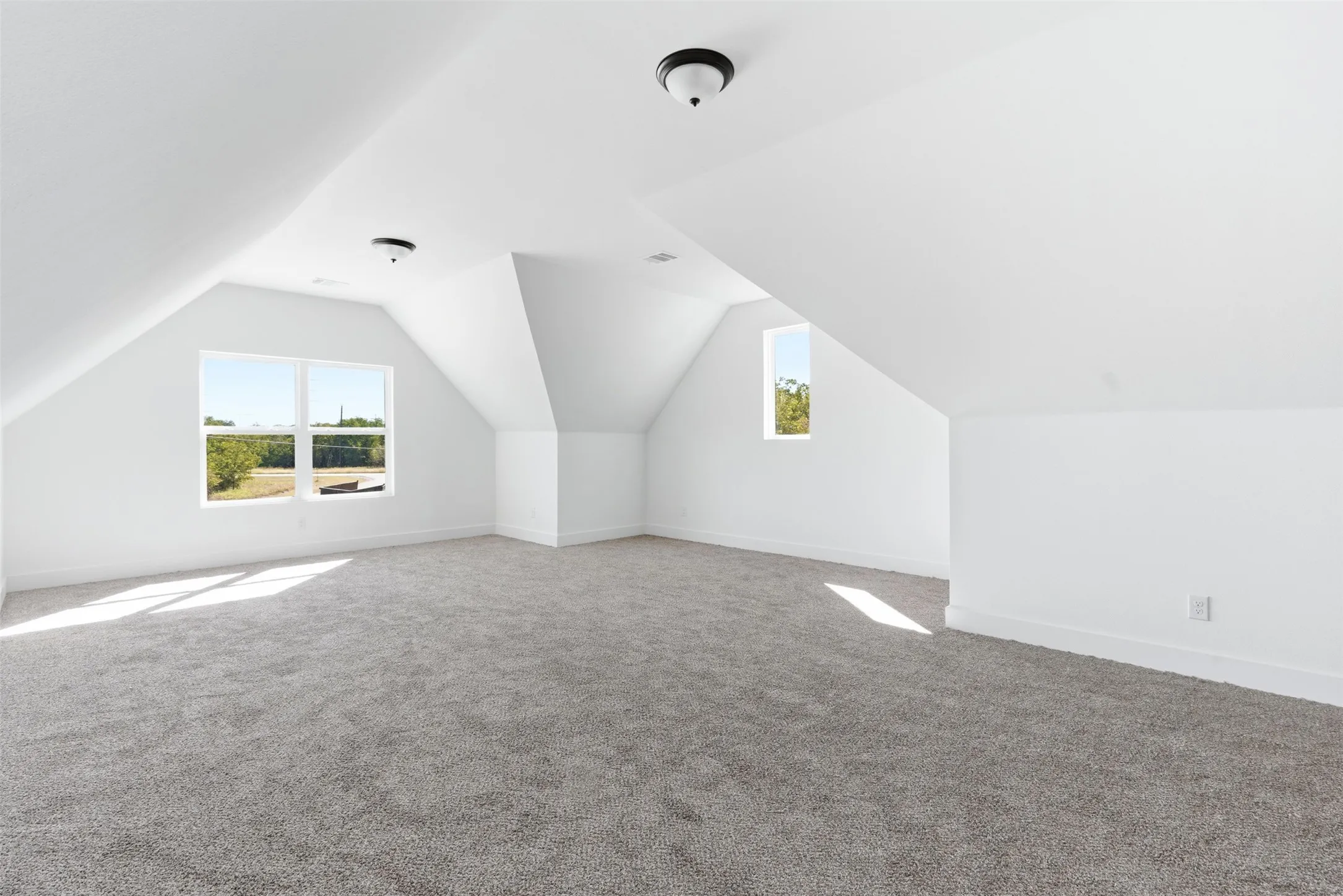 Additional living space with lofted ceiling and carpet