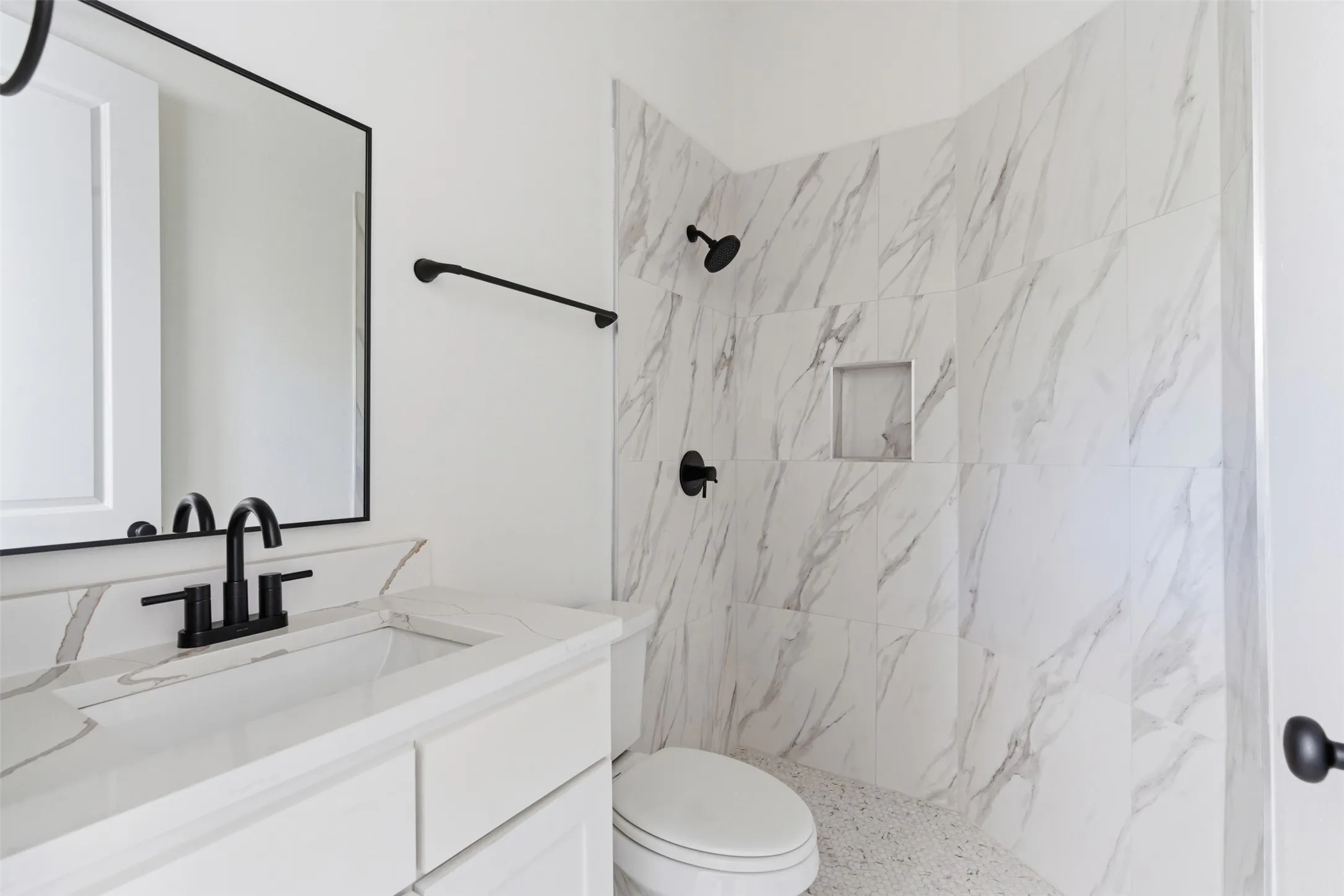 Full bath with vanity and a marble finish shower
