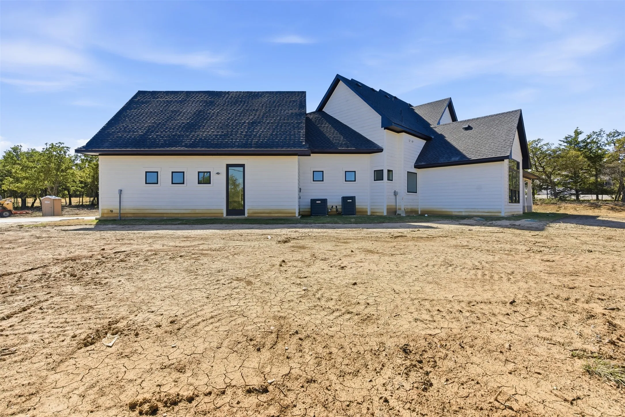 Back of house featuring a shingled roof