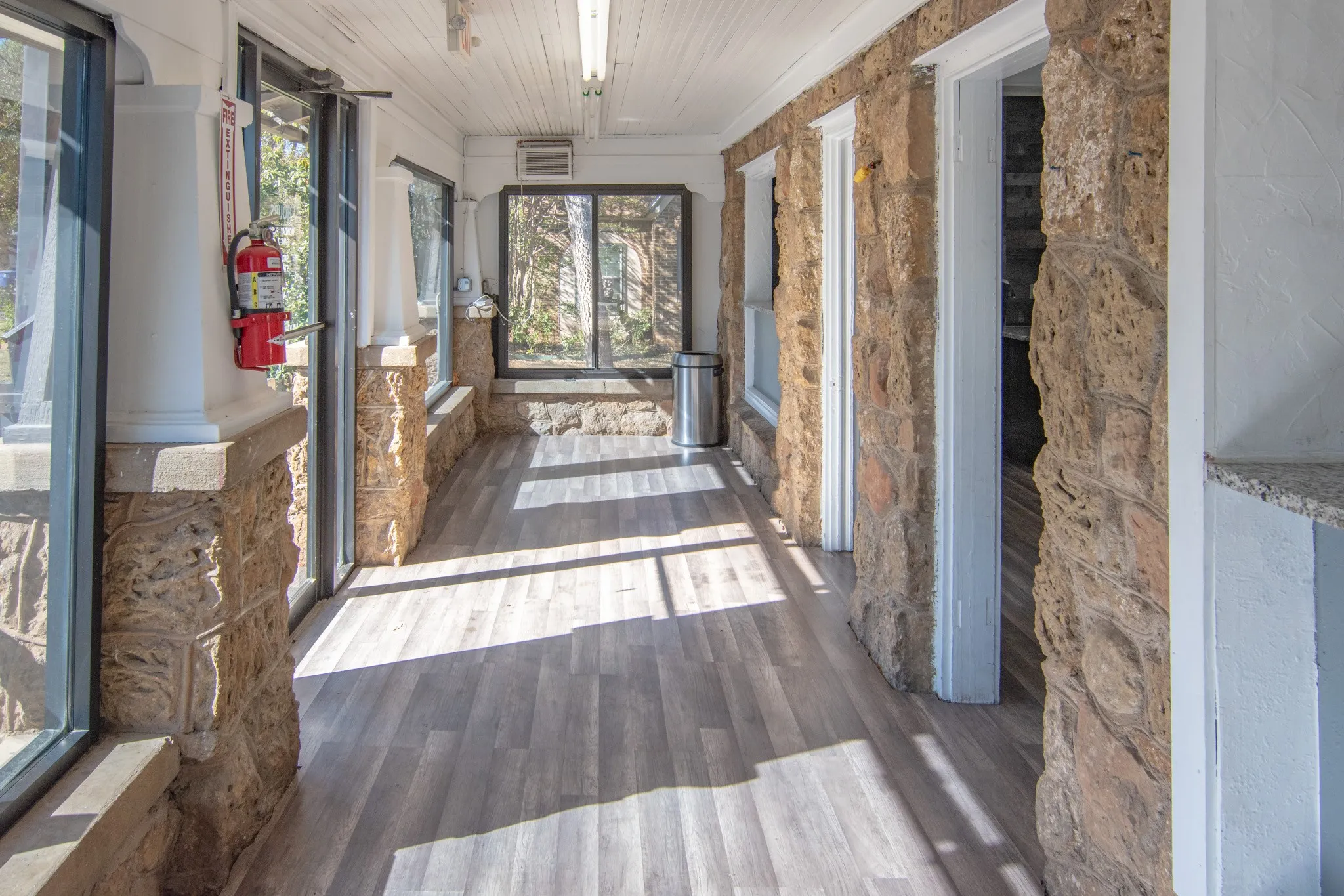 Unfurnished sunroom featuring wood finished floors and wood ceiling