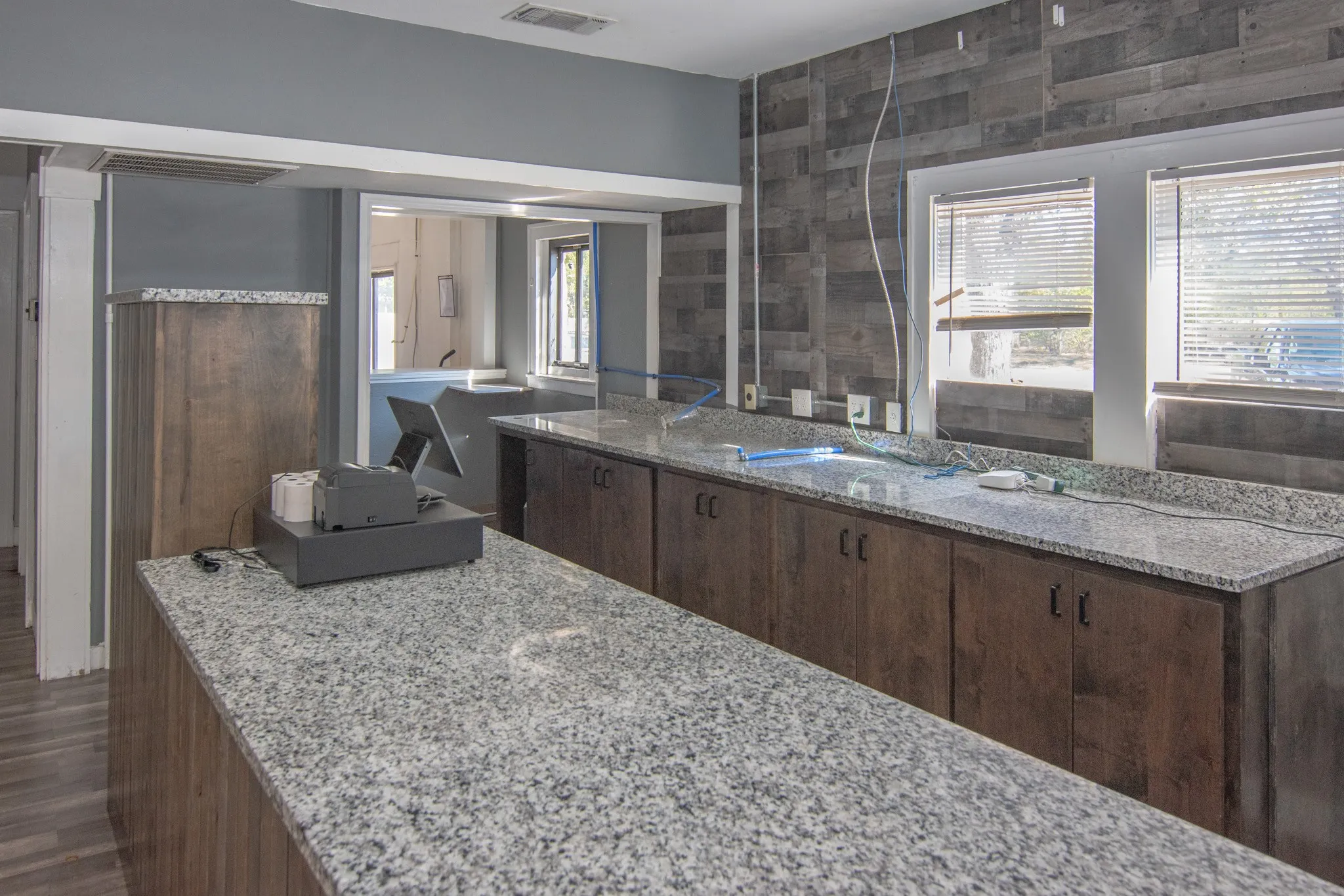 Bathroom featuring vanity, dark wood-style floors, and tile walls