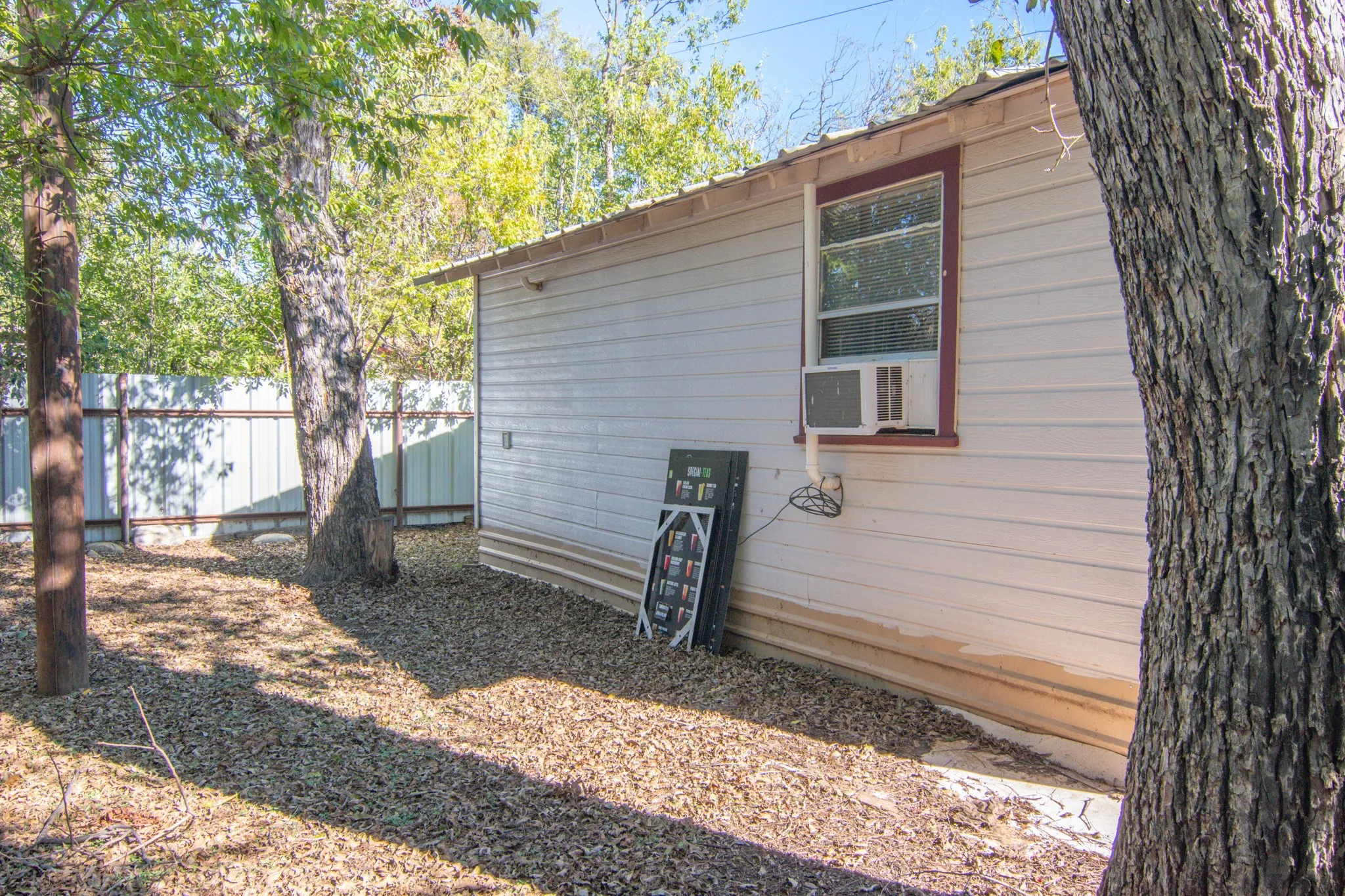 View of side of property featuring cooling unit
