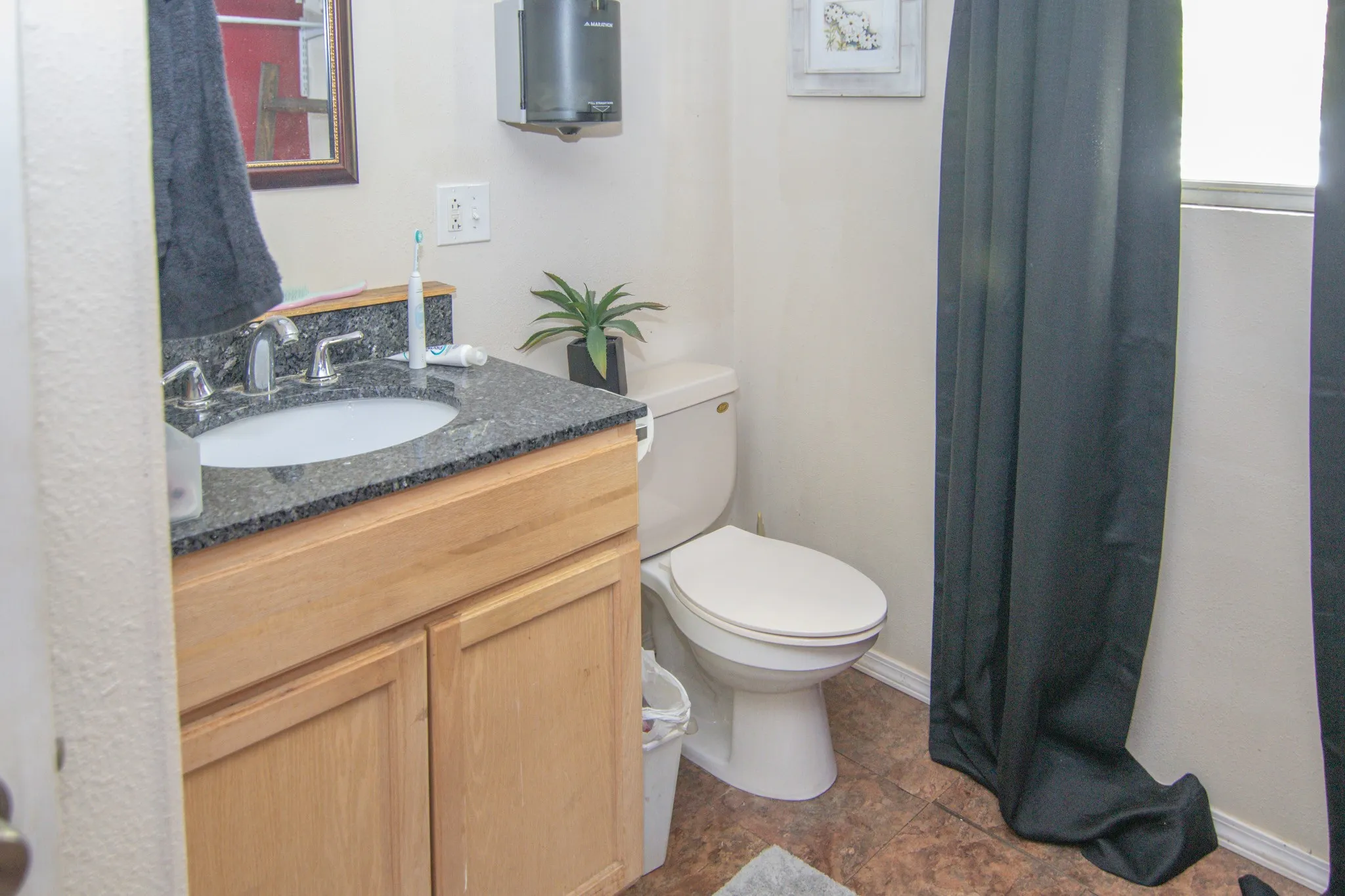 Bathroom with vanity and a shower with shower curtain