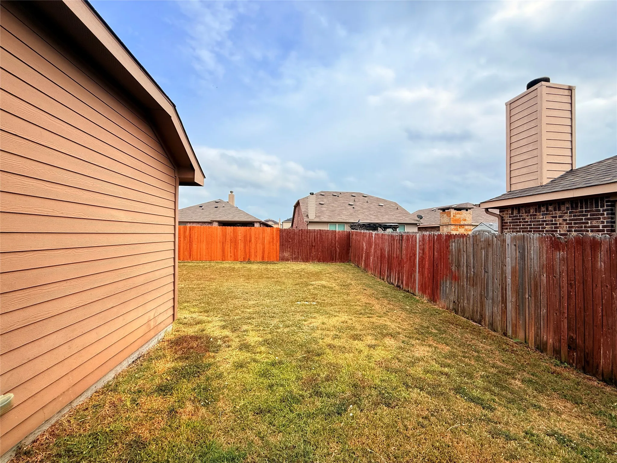 View of fenced backyard