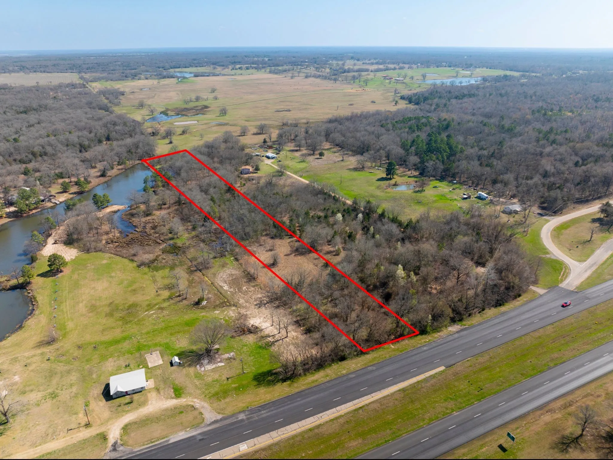 Aerial view of sparsely populated area with property parcel outlined