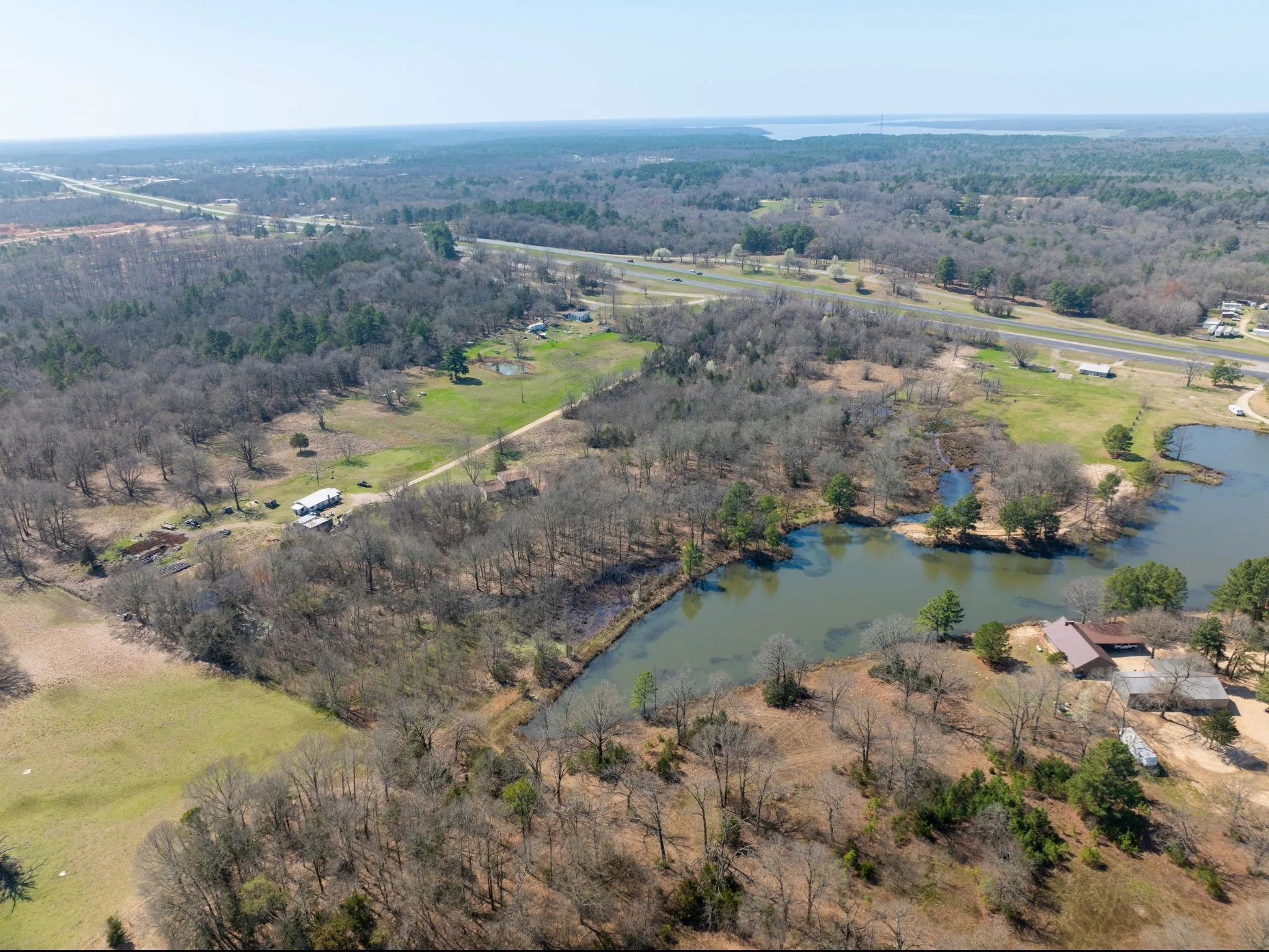 Aerial view of property and surrounding area featuring a large body of water