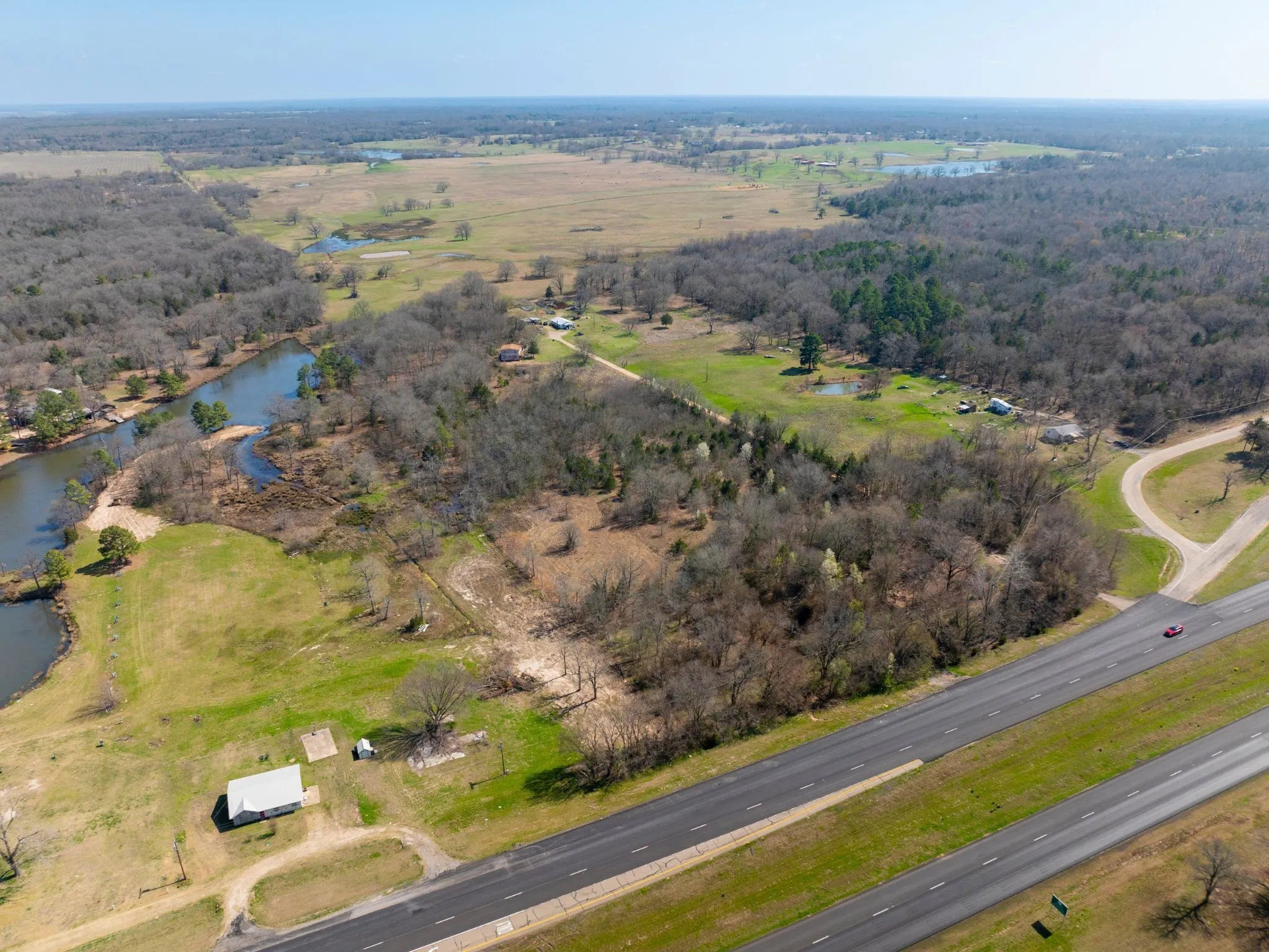 Aerial view of property's location with rural landscape and a large body of water
