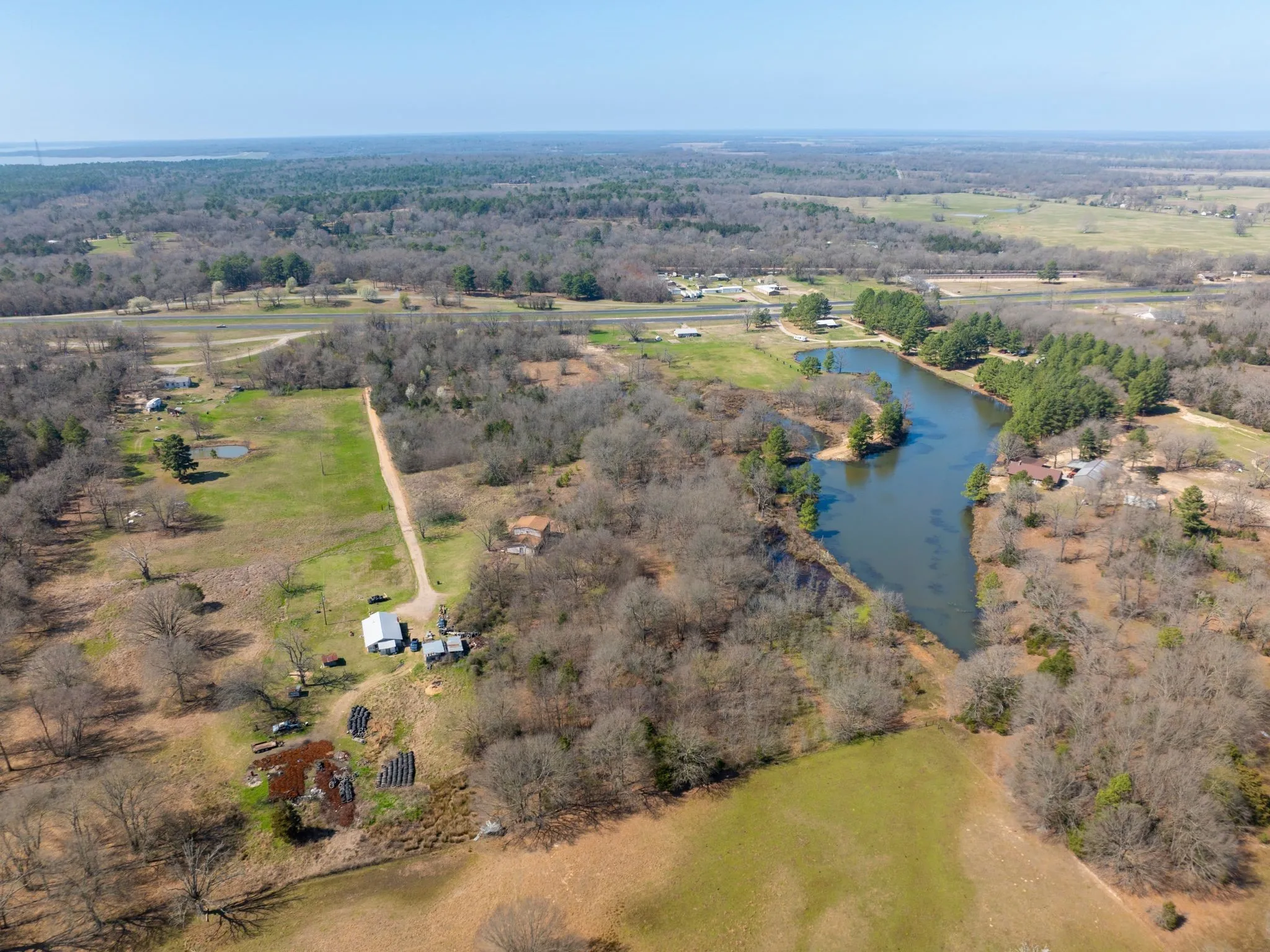 Aerial view of property's location with a large body of water and rural landscape