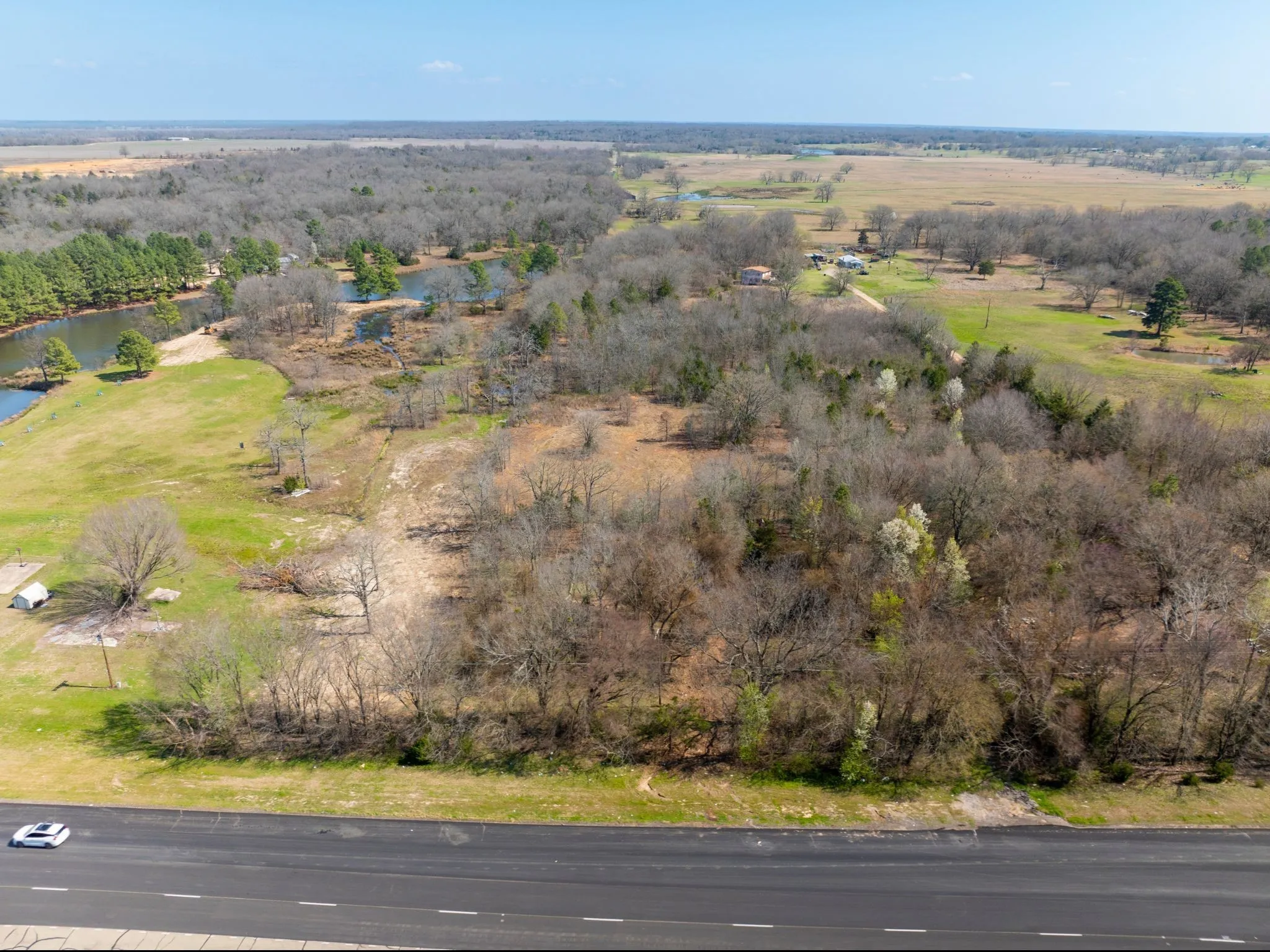Aerial overview of property's location with a nearby body of water