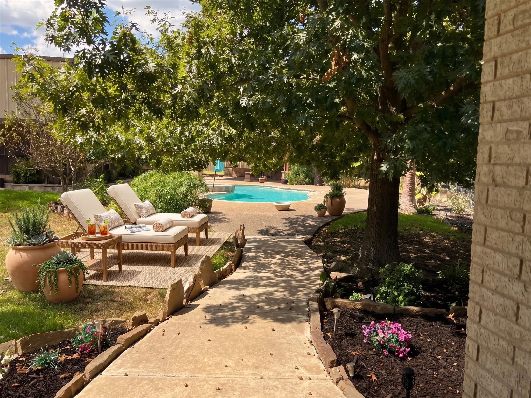 Expansive outdoor area featuring a geometric swimming pool, mature trees, and a concrete pathway