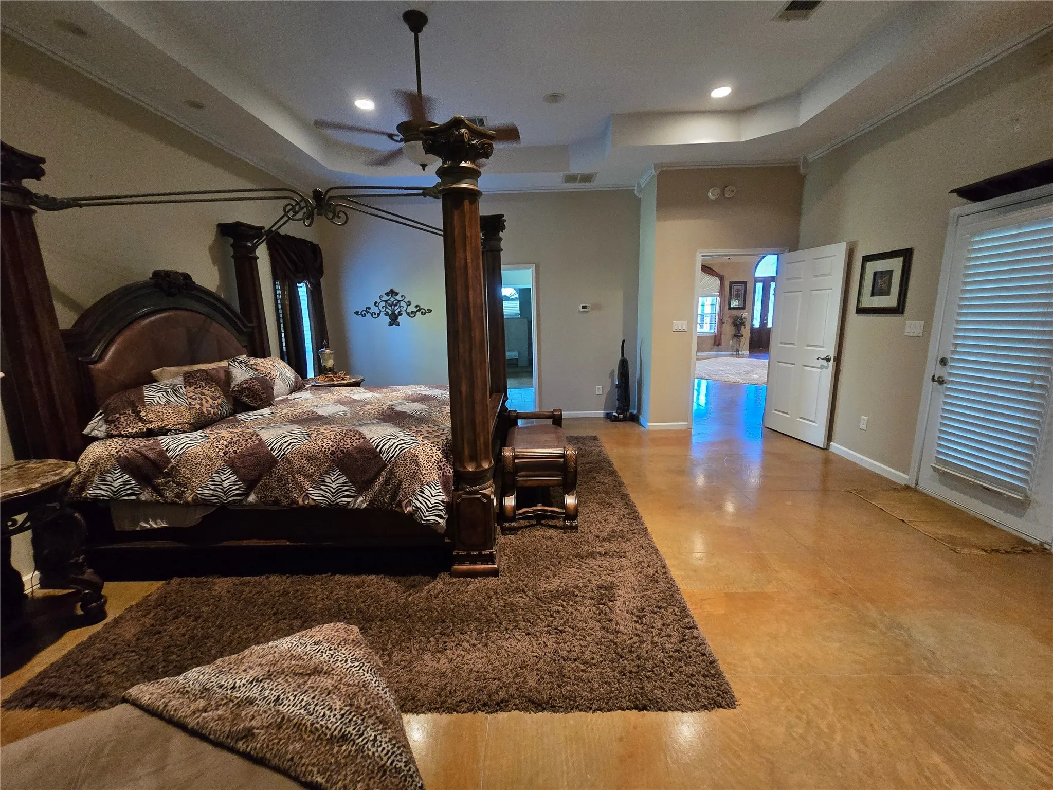 Bedroom featuring a raised ceiling, recessed lighting, and ceiling fan